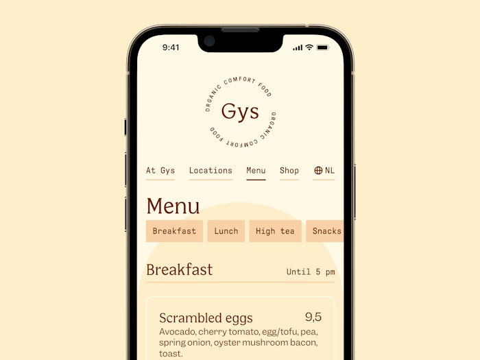 A phone dislaying the new site. The active page is the menu, on which a first menu item is visible: scrambled eggs. Above the item sits a row of buttons with labels like 'breakfast', 'lunch', 'high tea' that bring the user to that group of menu items on the page.
