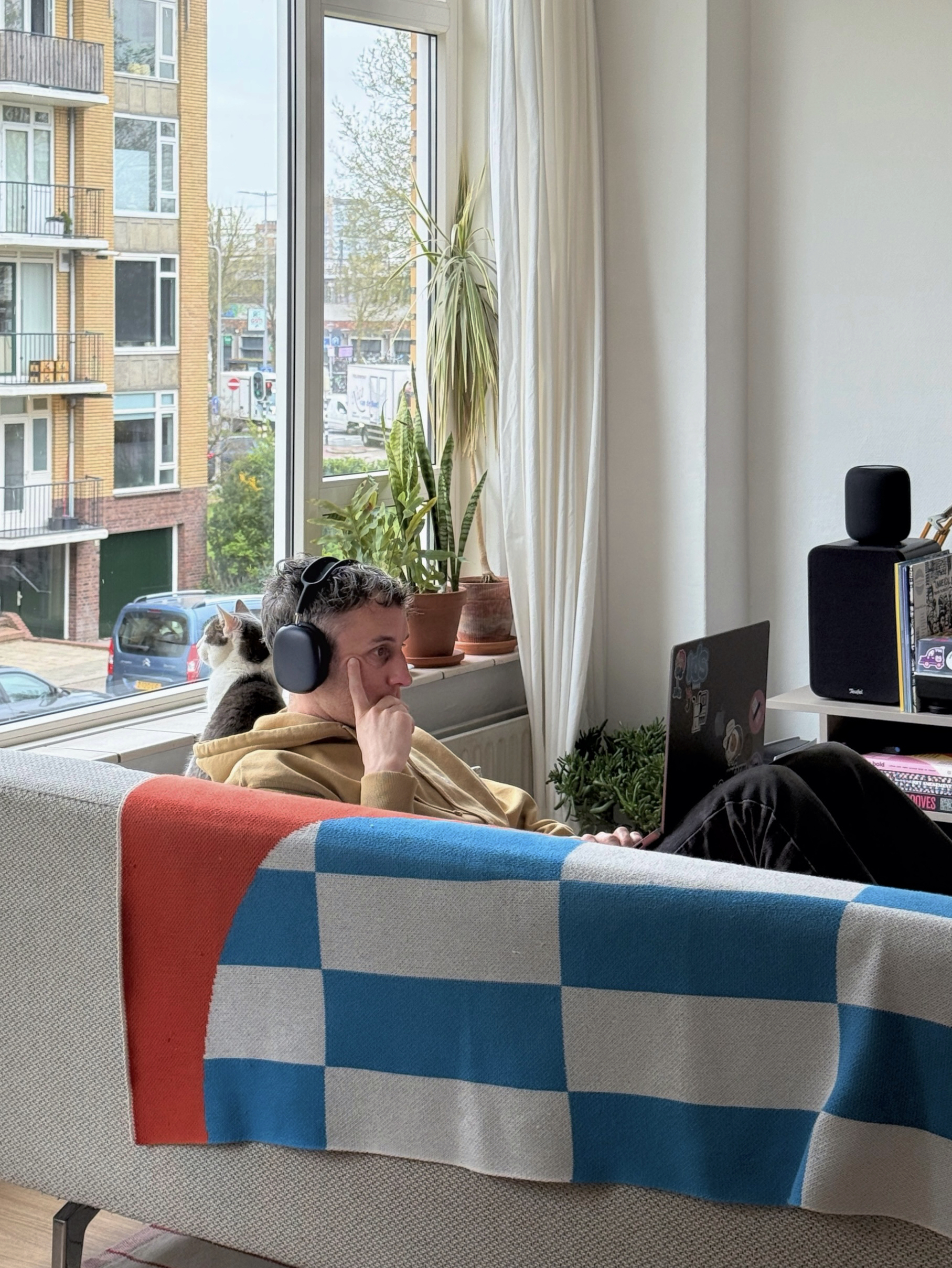 Martijn, sitting on the couch together with his cat Poes, laptop on my lap, thinking hard