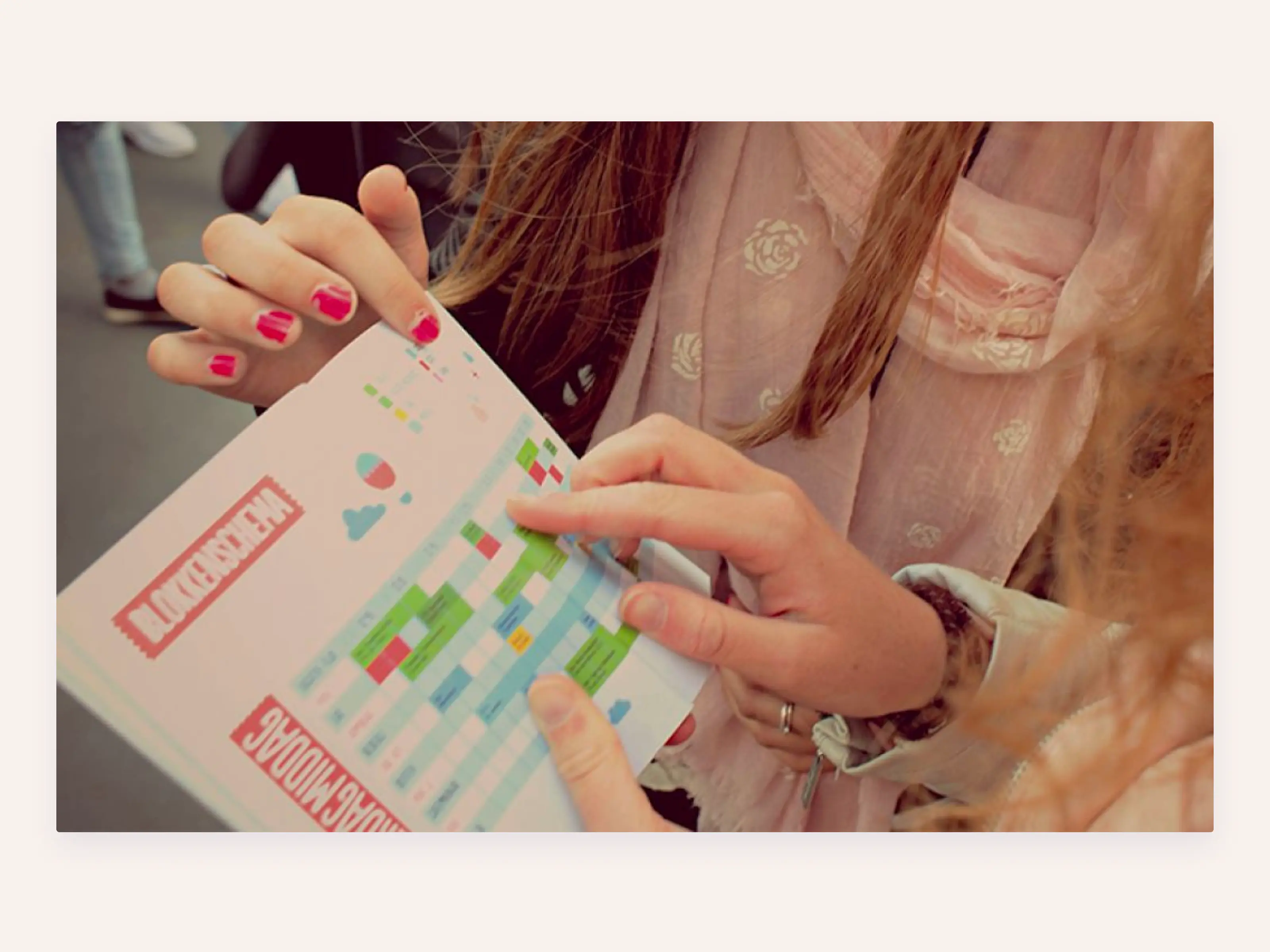 People figuring out a printed time table.