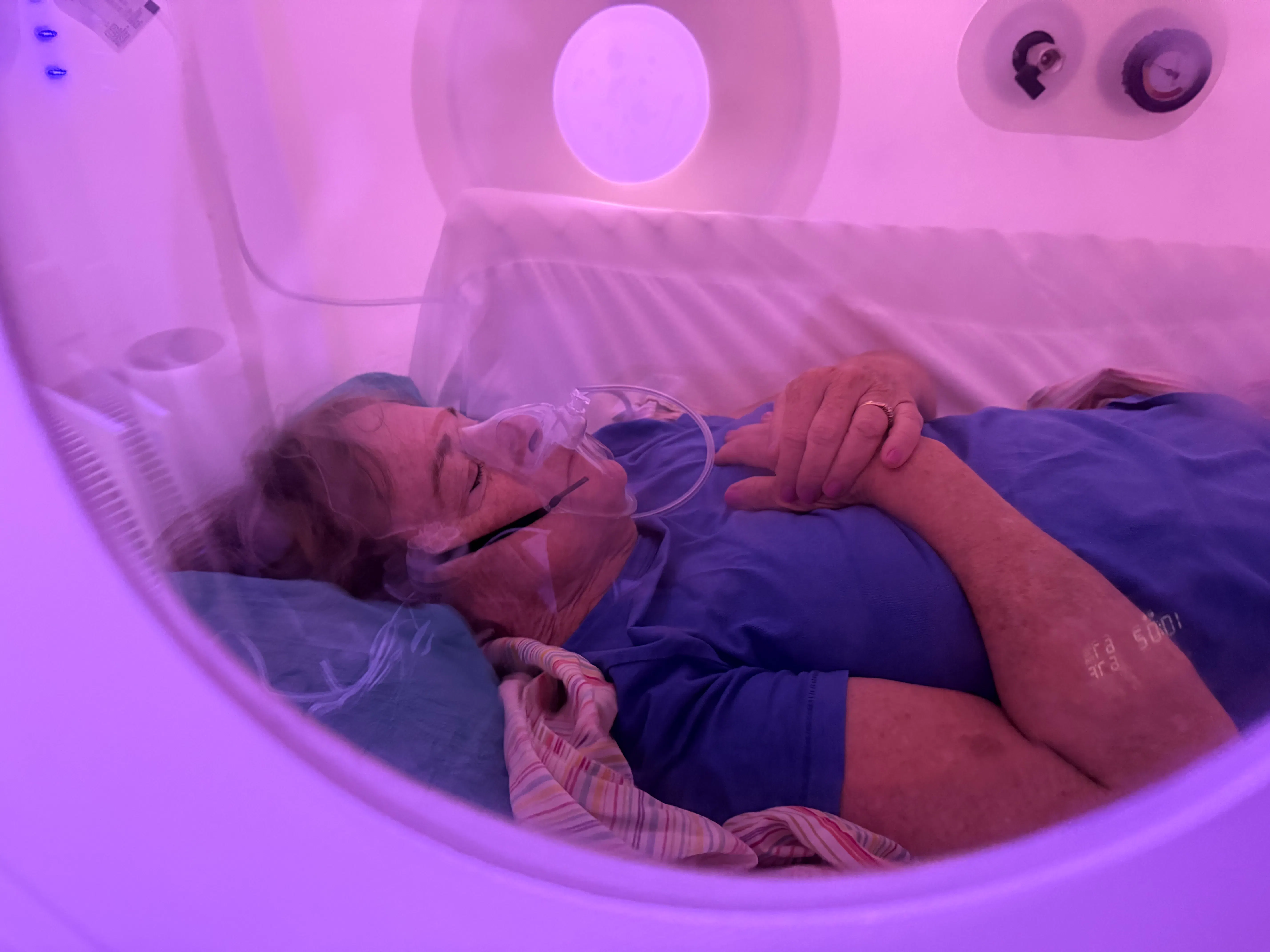 A client relaxing inside the hyperbaric chamber