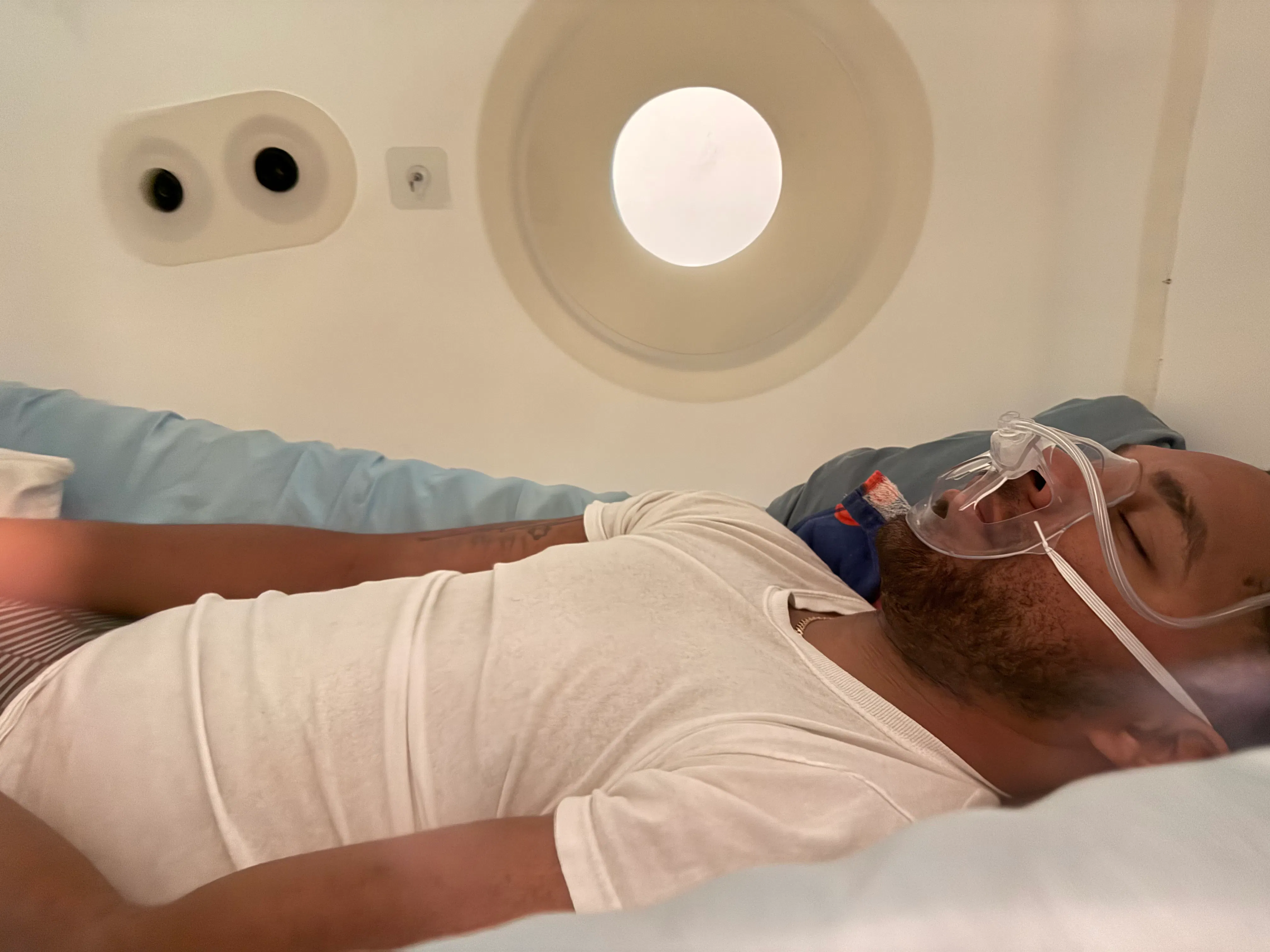 A client relaxing inside the hyperbaric chamber