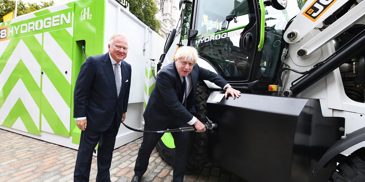 Lord Bamford hejar på när premiärminister Boris Johnson tankar vätgas i den nya prototypmaskinen.