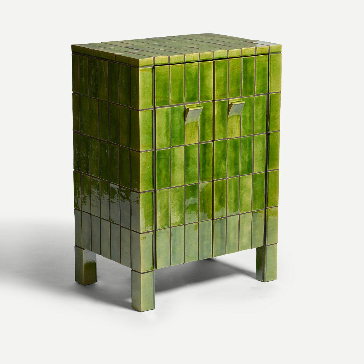 A green tiled cupboard against a white background