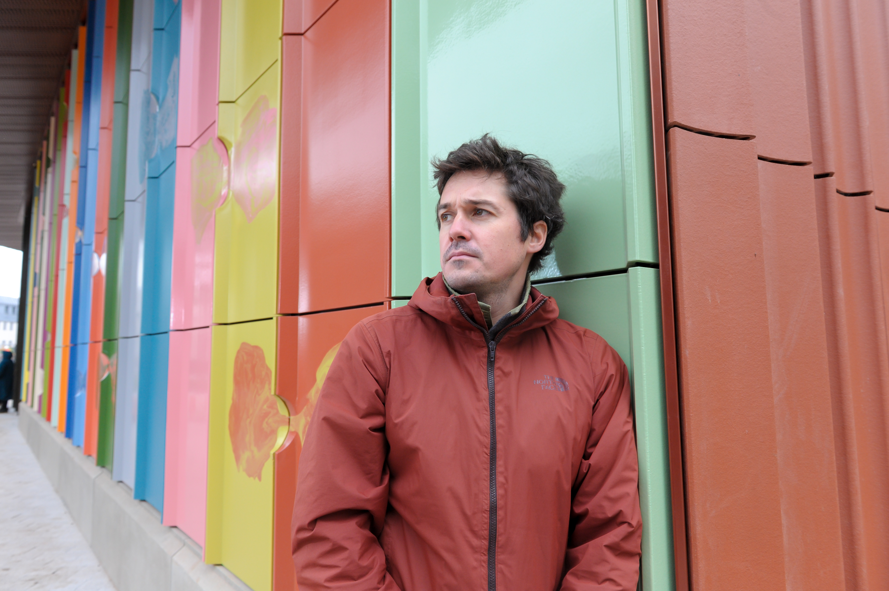 Matthew Raw standing in front of his artwork at the University of Warwick