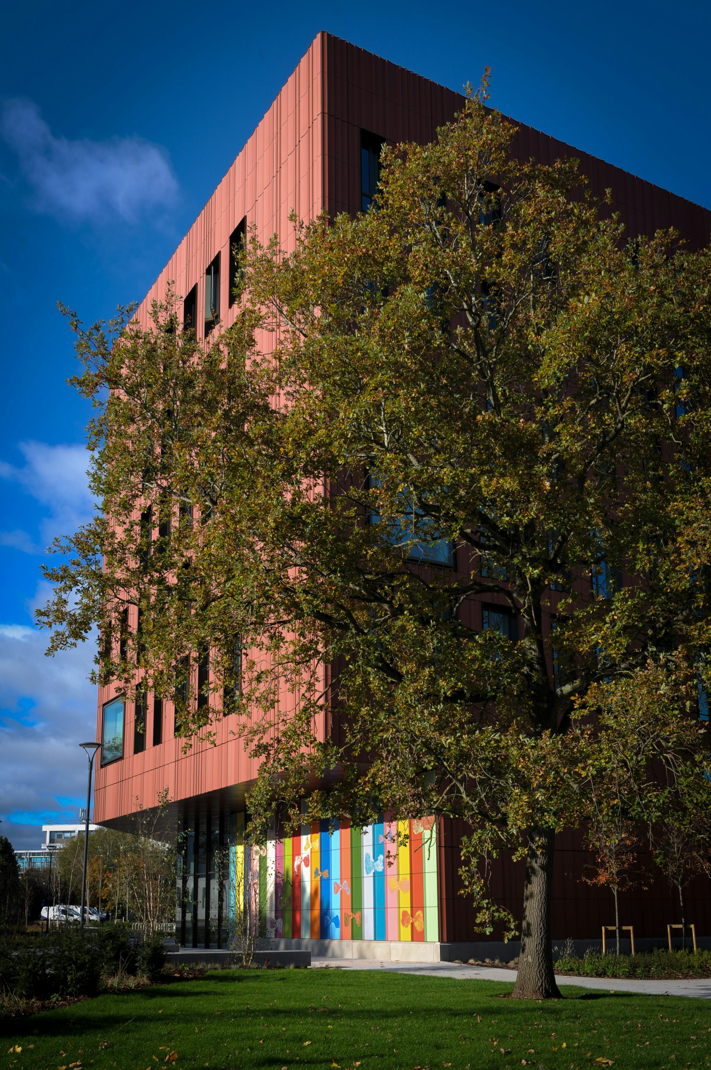 An artwork of large, colourful tiles on a new building at the University of Warwick