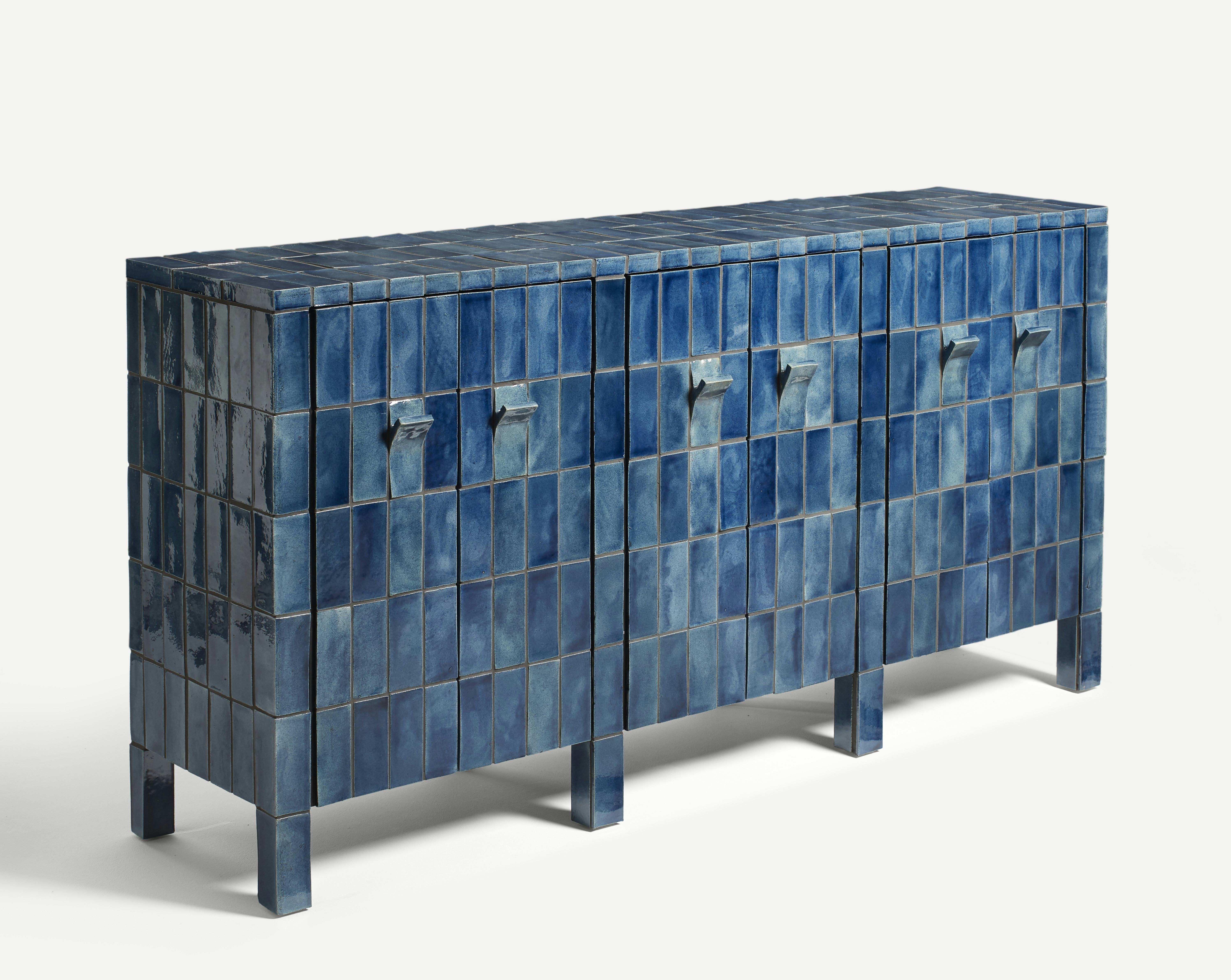 A sideboard clad in handmade blue tiles