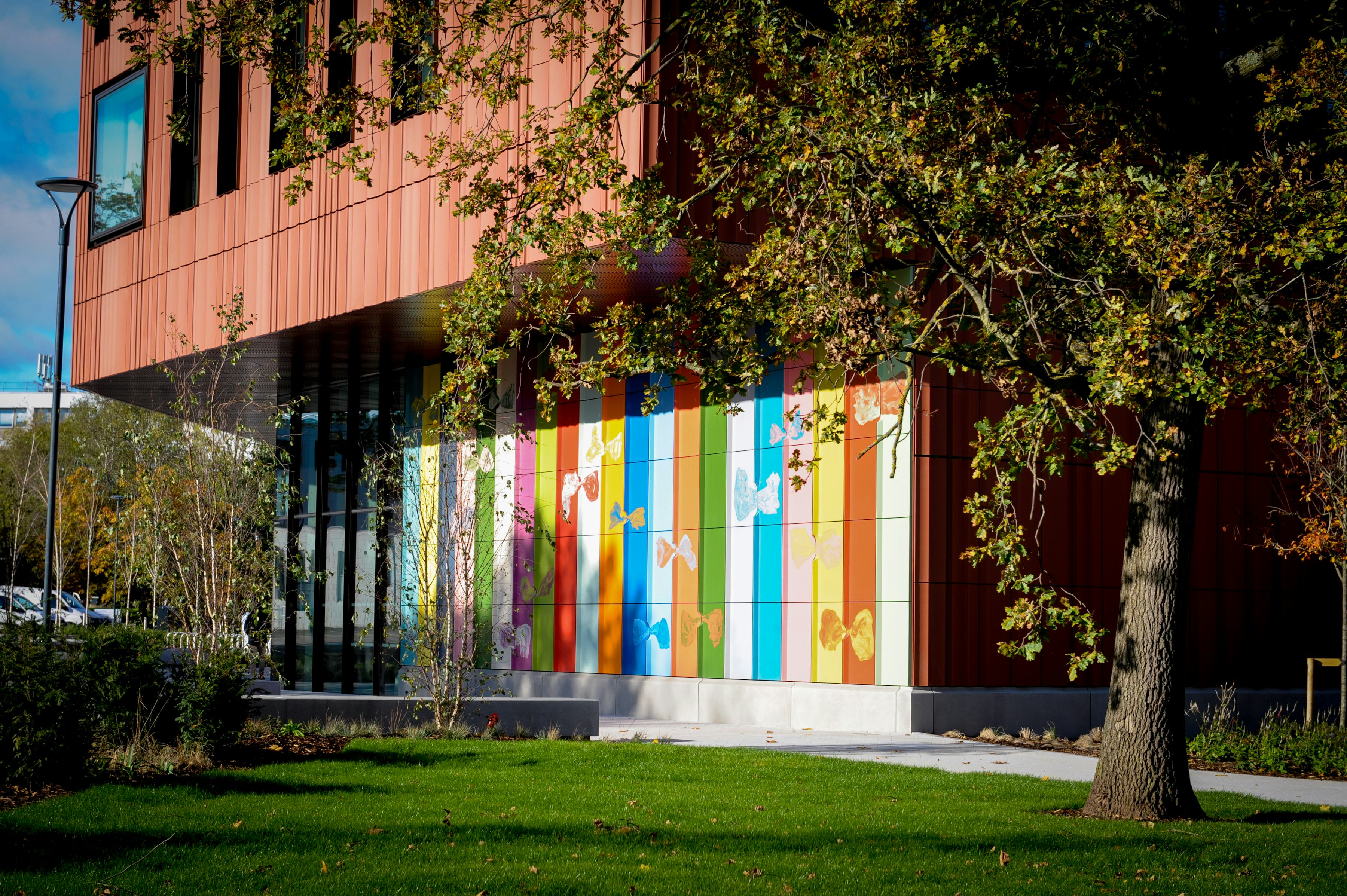 An artwork of large, colourful tiles on a new building at the University of Warwick