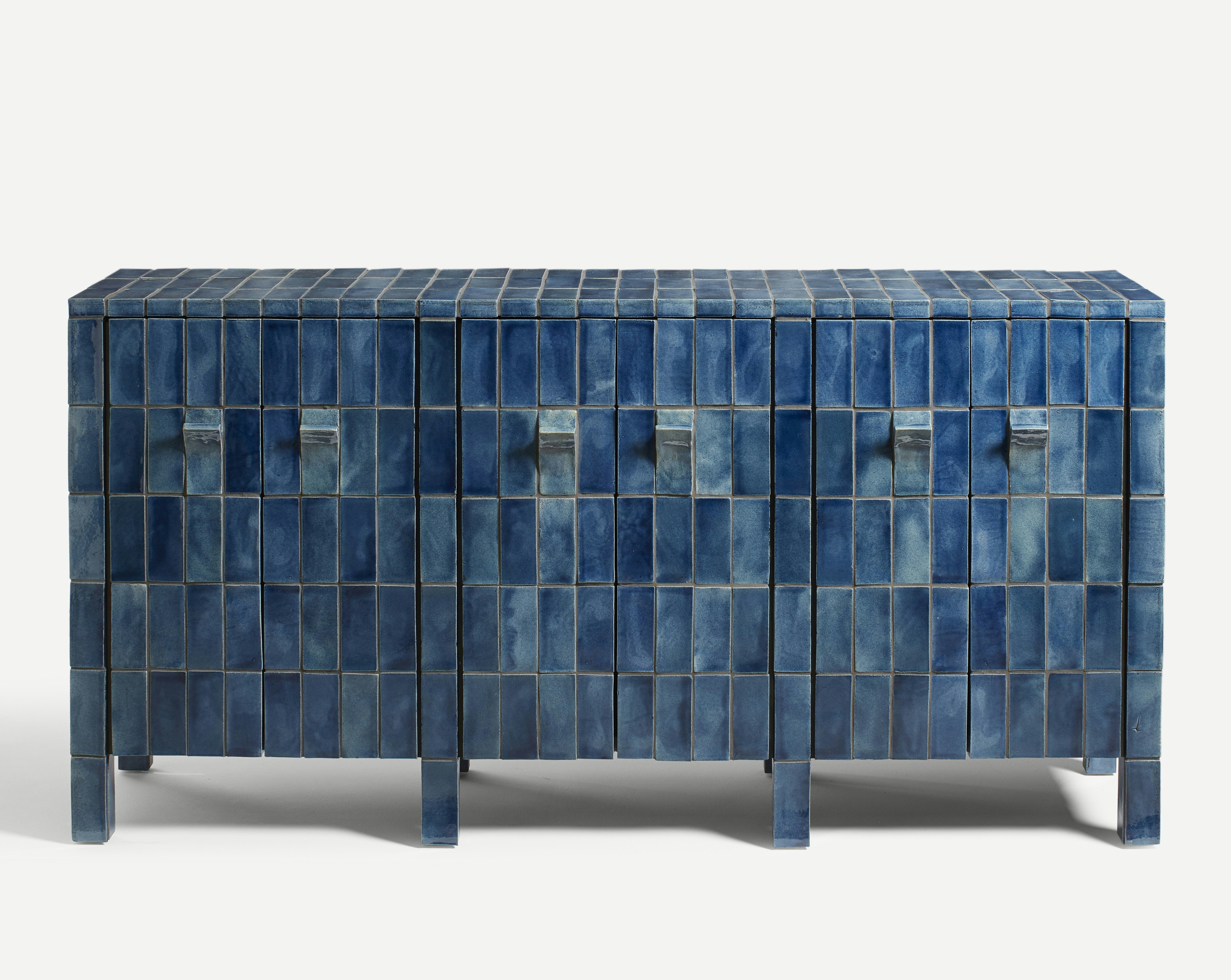 A sideboard clad in handmade blue tiles