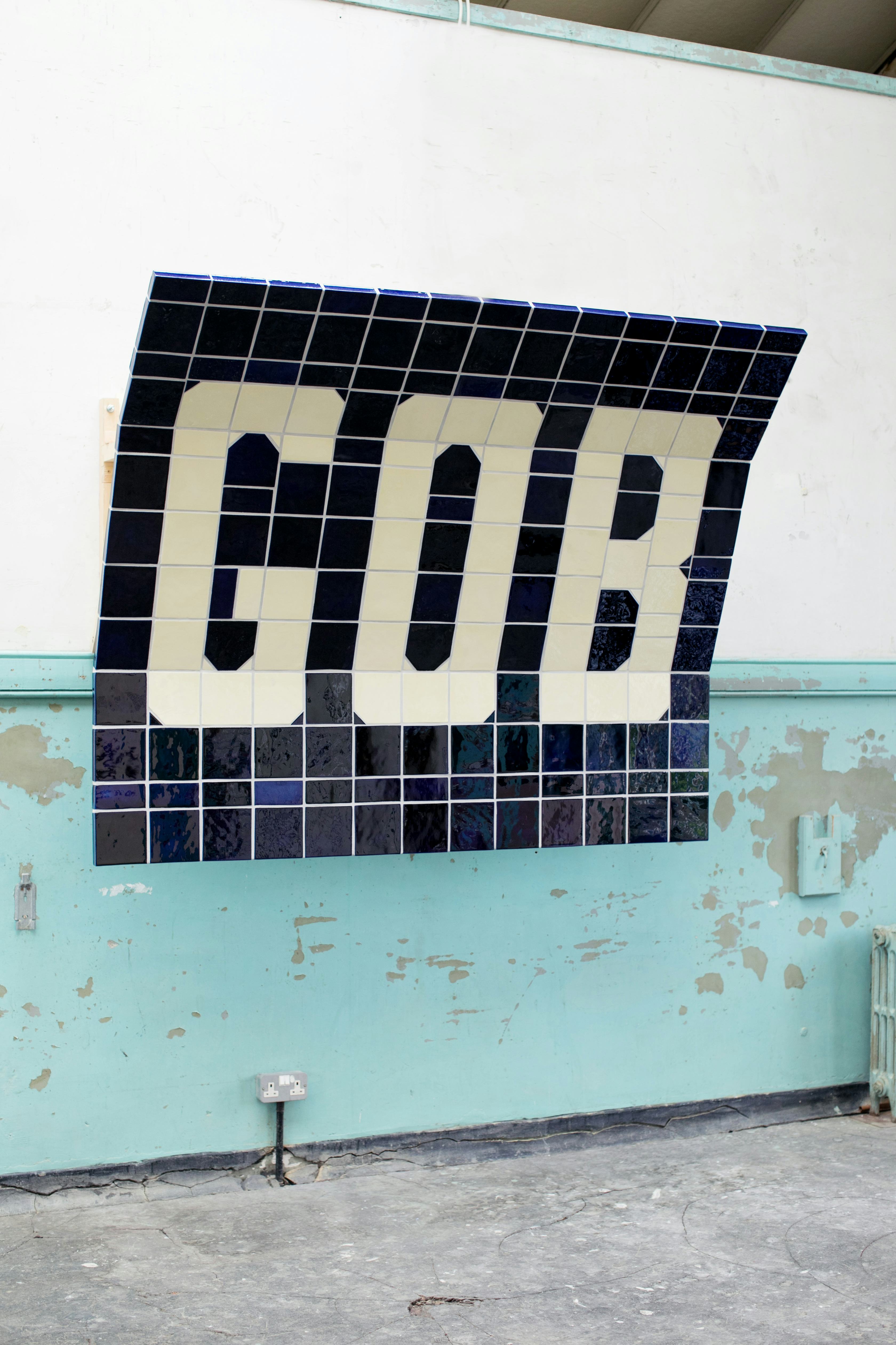 A tiled artwork spelling the letters G O B