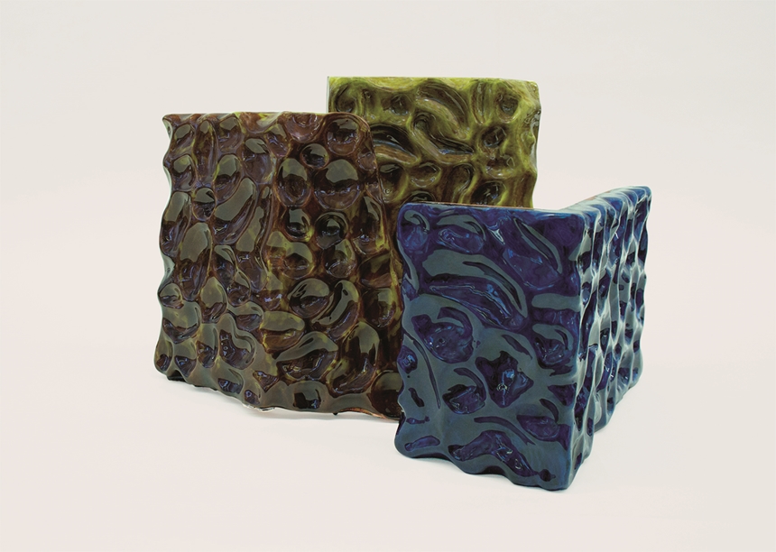 Three ceramic artworks against a white background