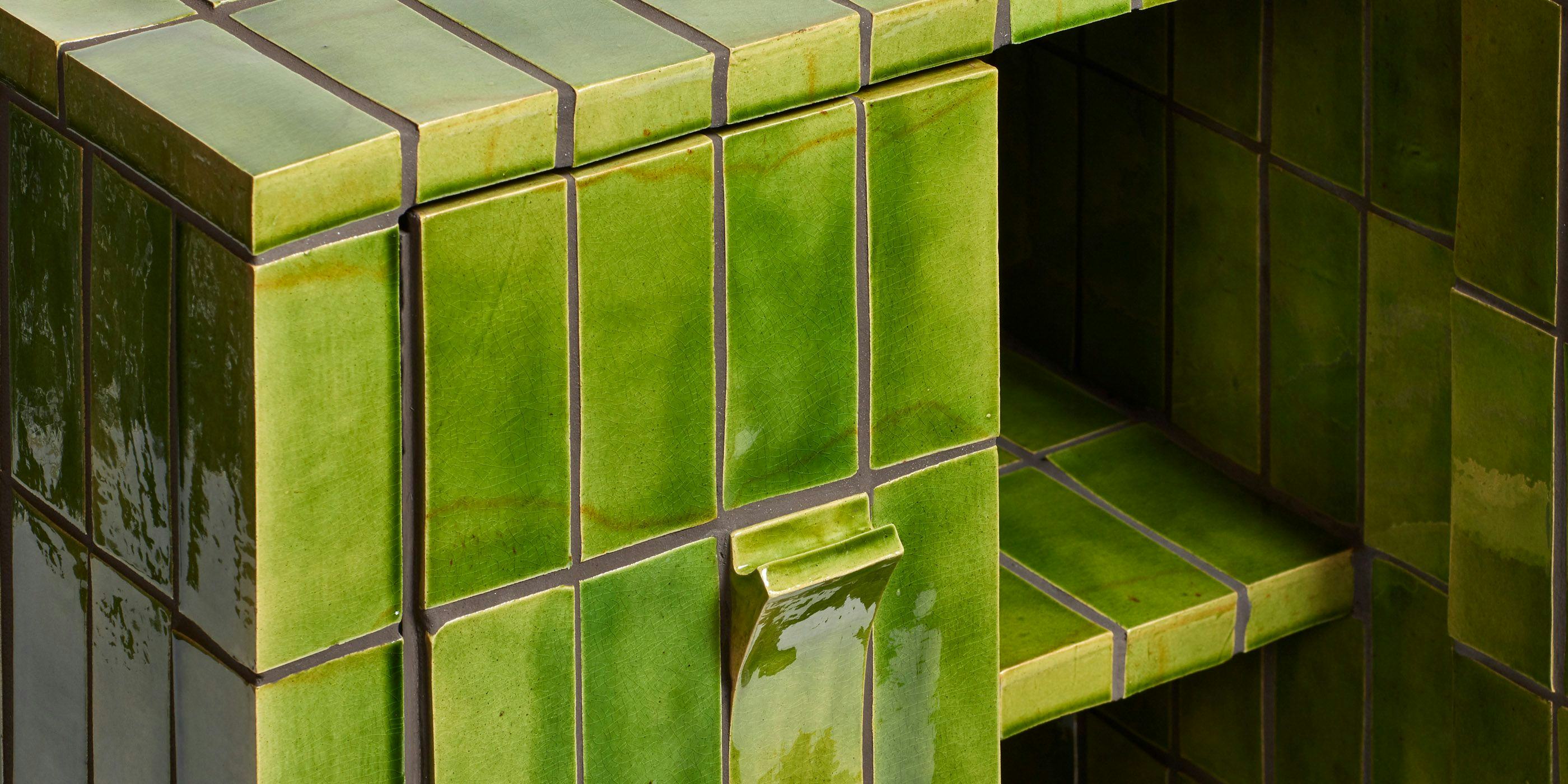 A detail of a green tiled cupboard showing the front and inside