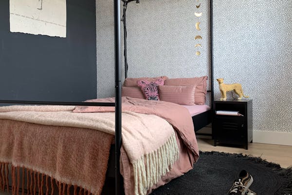 Black bedside table by the bed in the bedroom