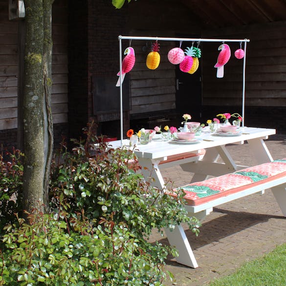 White picnic table with decoration frame ready for a party! 