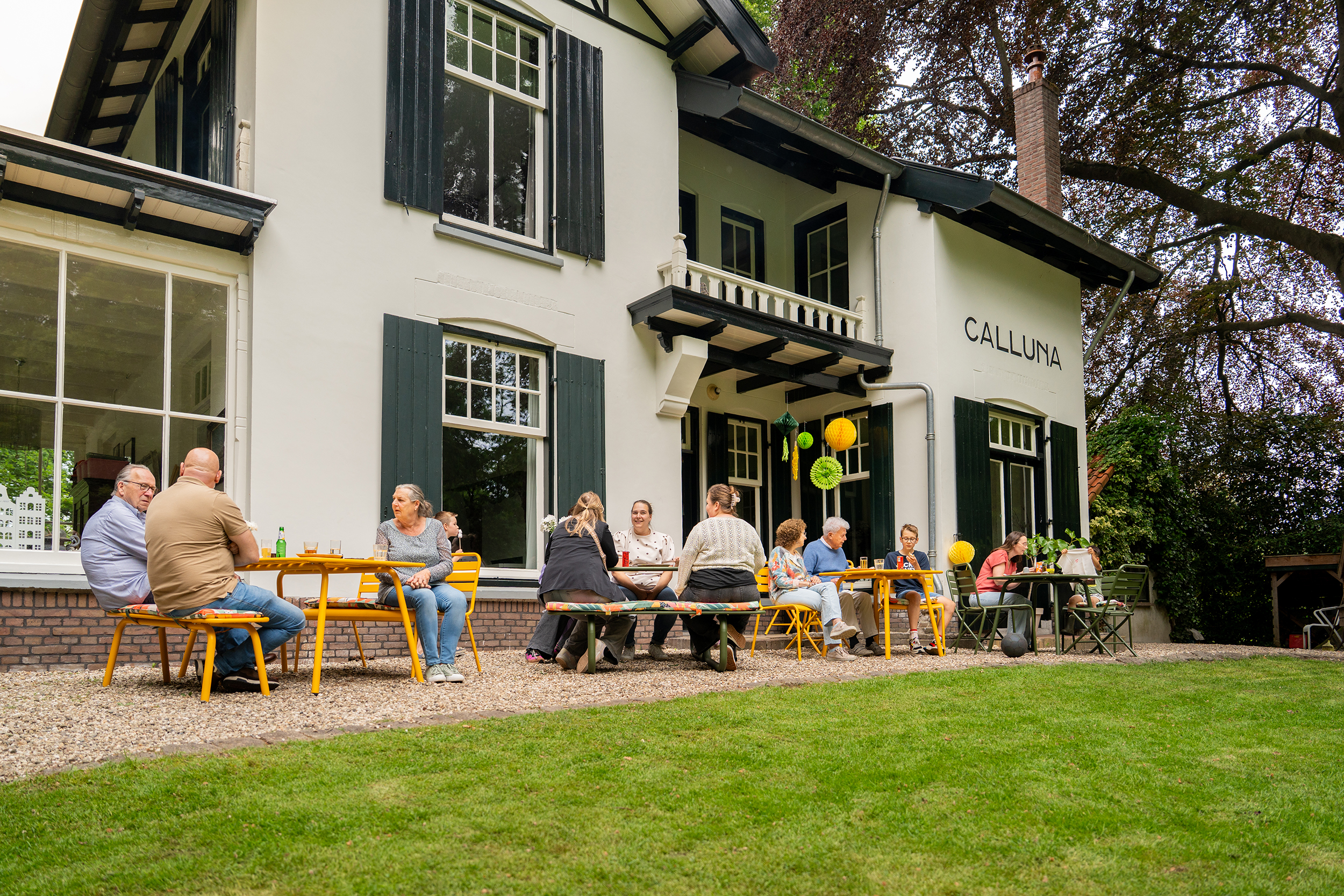 family enjoying a terrace with colourful outdoor furniture