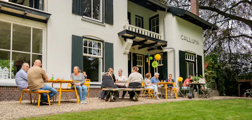 family enjoying a terrace with colourful outdoor furniture