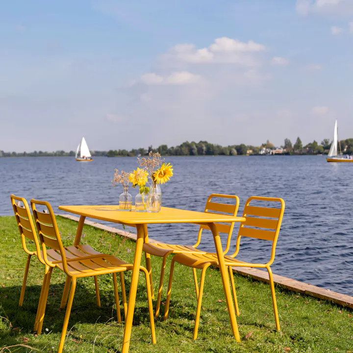 Ochre yellow Max metal garden set by the water