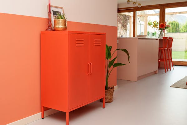 Finn metal locker cabinet in orange in the living room