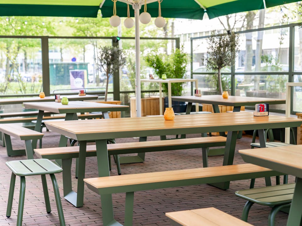 Olive green Bermuda picnic table on the terrace of House of Watt