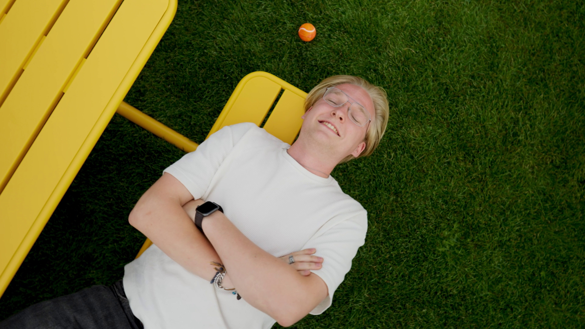 Outside is a playing field with a colourful picnic table.