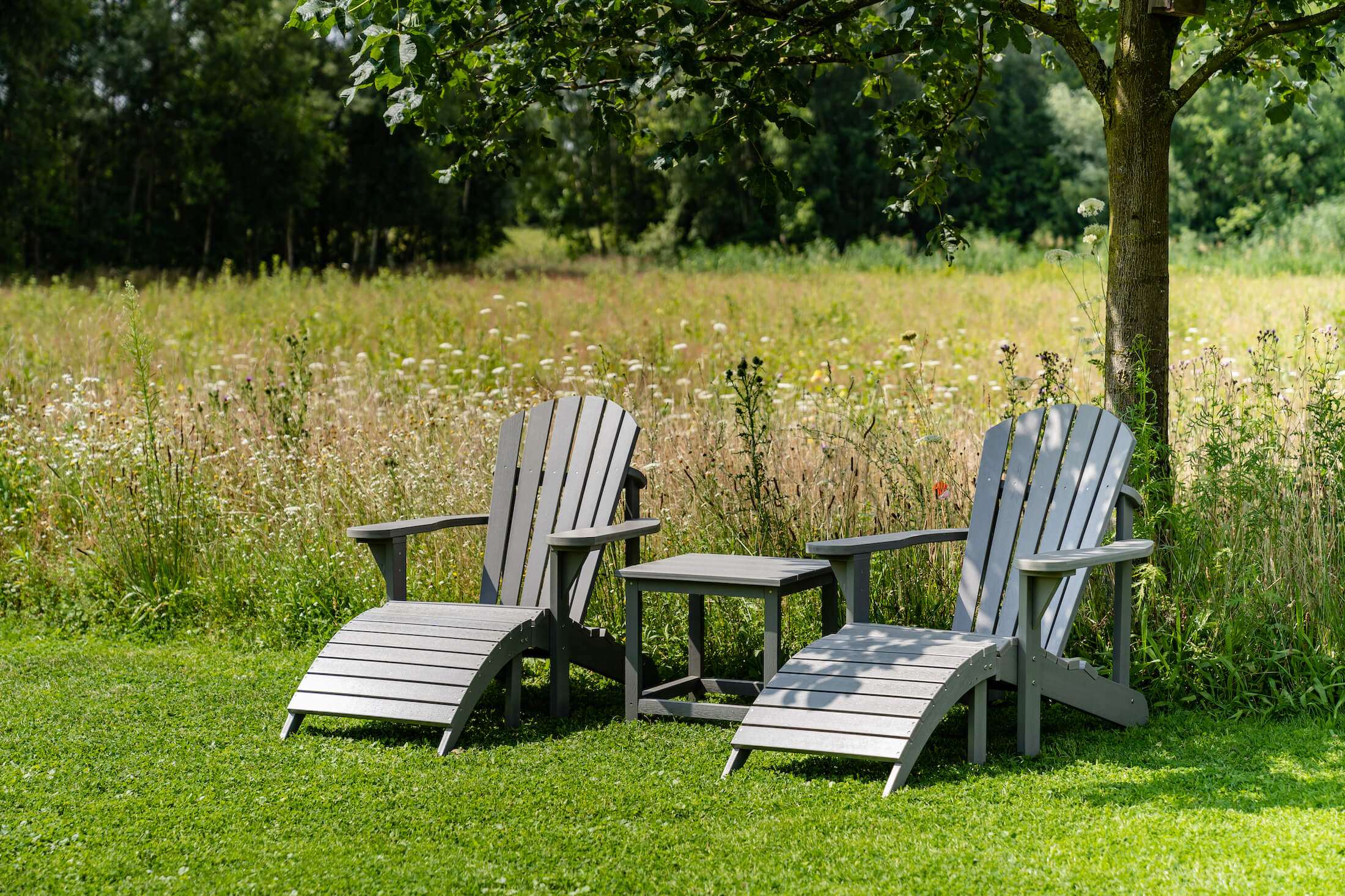 Grey Montreal Adirondack chair in the garden