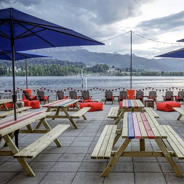 The terrace of The Harrison Spirit in Switzerland with picnic tables from MaximaVida 