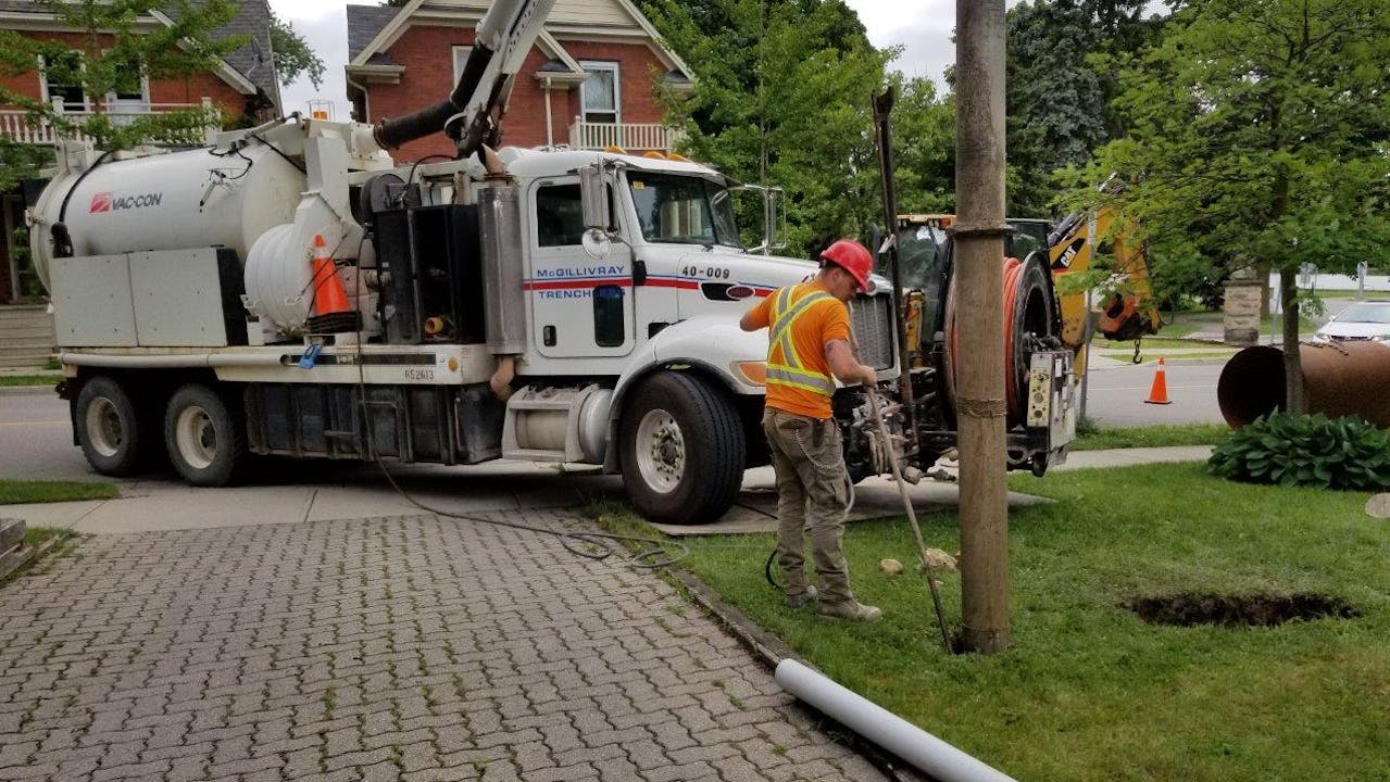Employee working with large truck in background