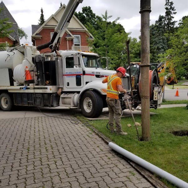 Employee working with large truck in background