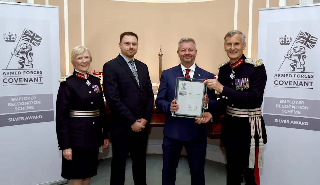 MCL representatives receiving the Ministry of Defence Employer Recognition Scheme Silver Award certificate at the South East ERS Awards 2026, pictured with a Lord-Lieutenant and Deputy Lord-Lieutenant in ceremonial uniform in front of Armed Forces Covenant Silver Award banners.