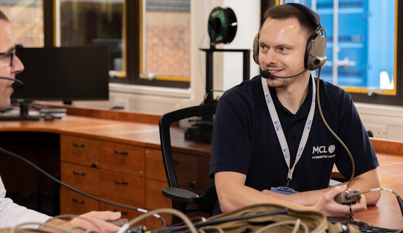 A man wearing a headset, focused on his work.