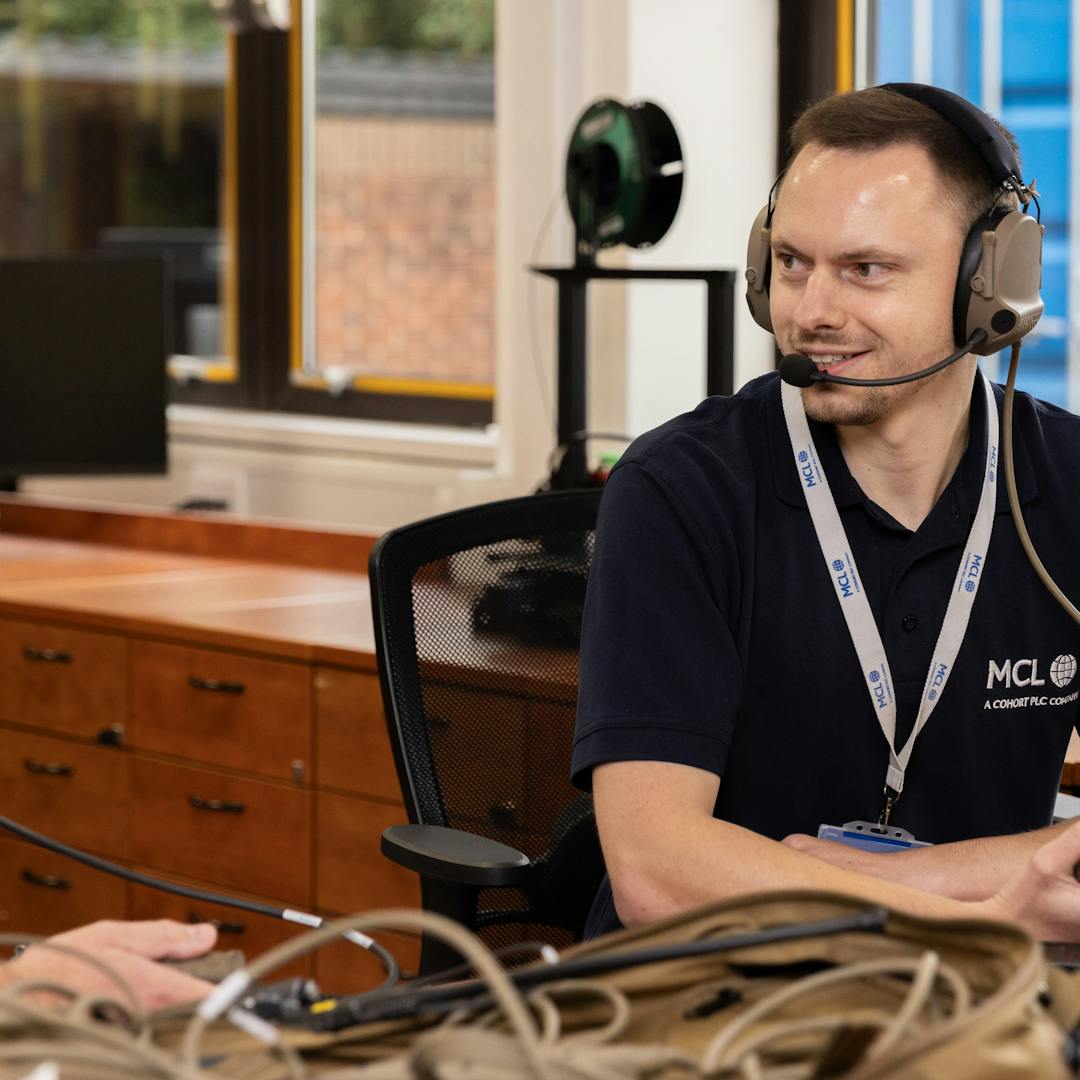 A man wearing a headset, focused on his work.