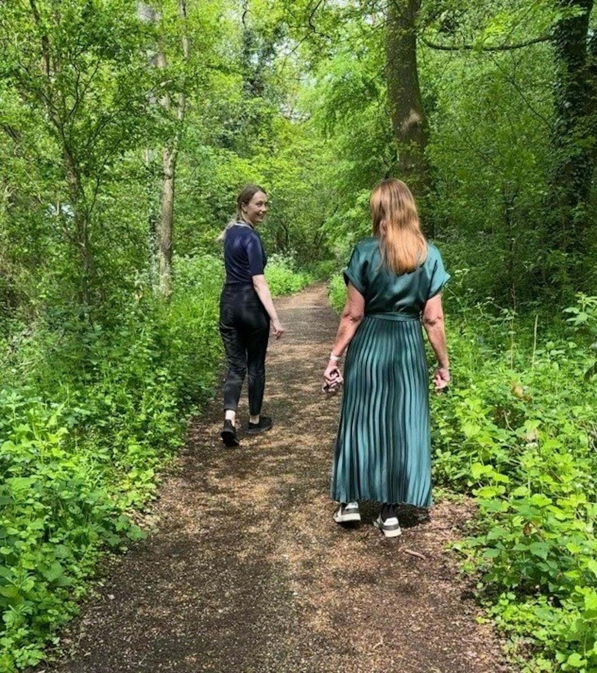 Team members out on a walk through a woods.