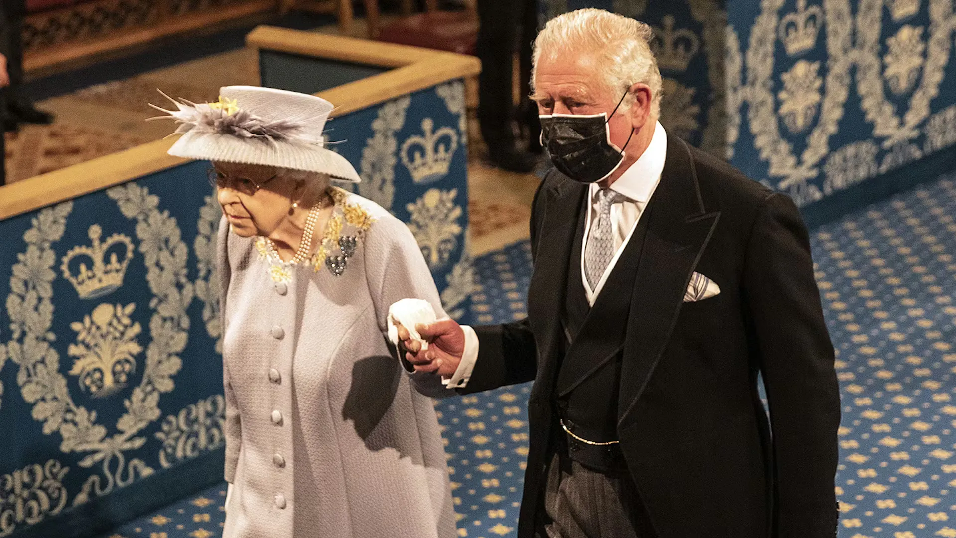 The Queen and Prince Charles wearing a mask