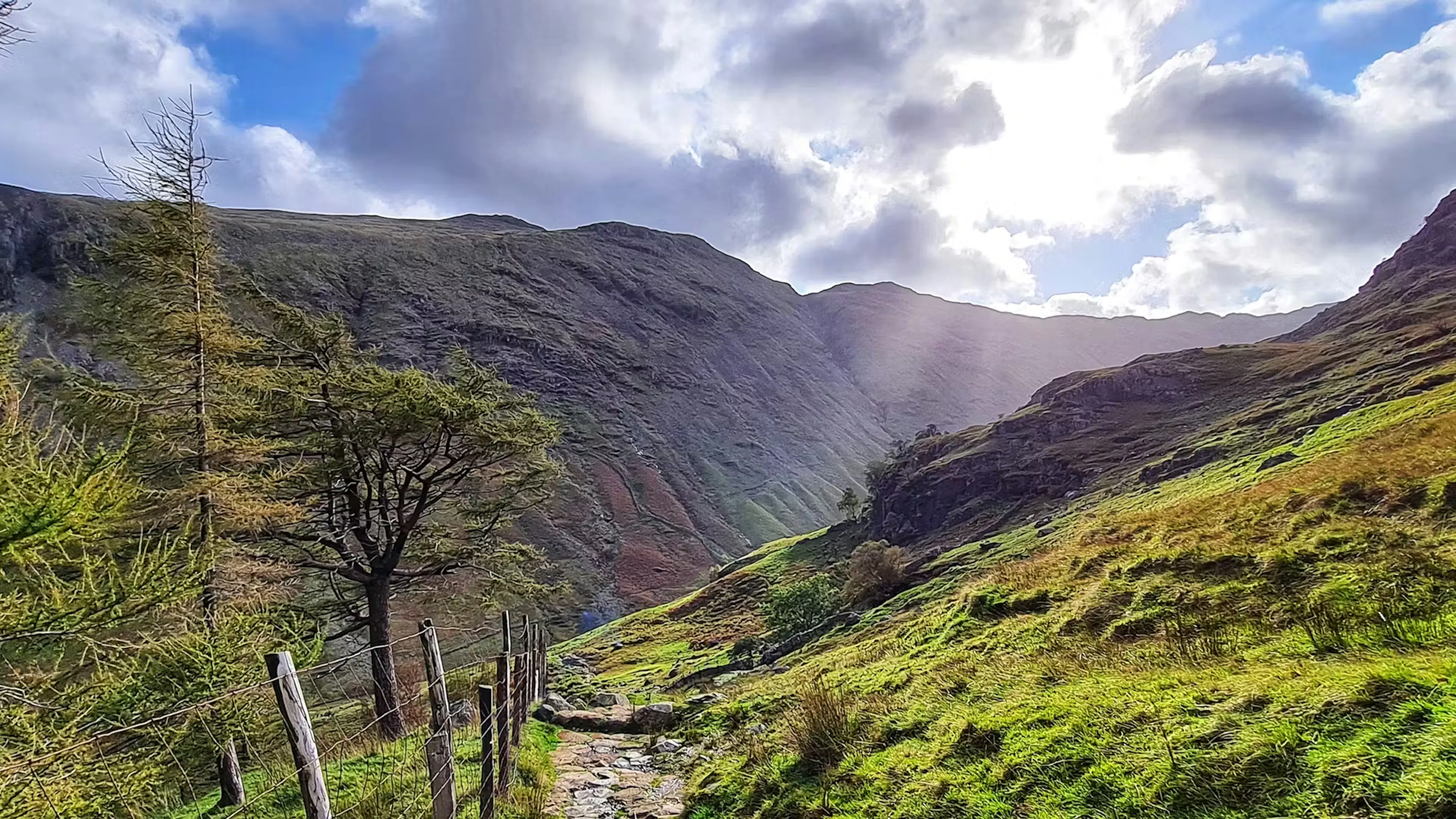 Sun bursting through the clouds over a valley