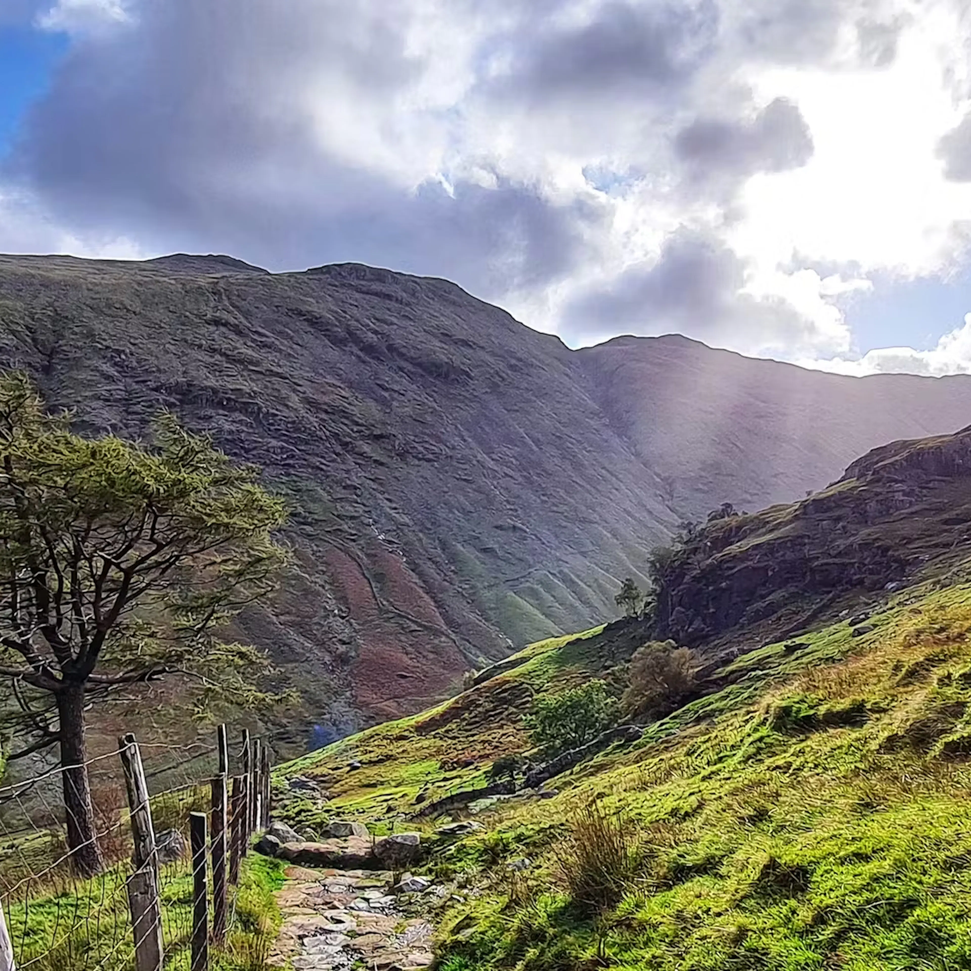 Sun bursting through the clouds over a valley