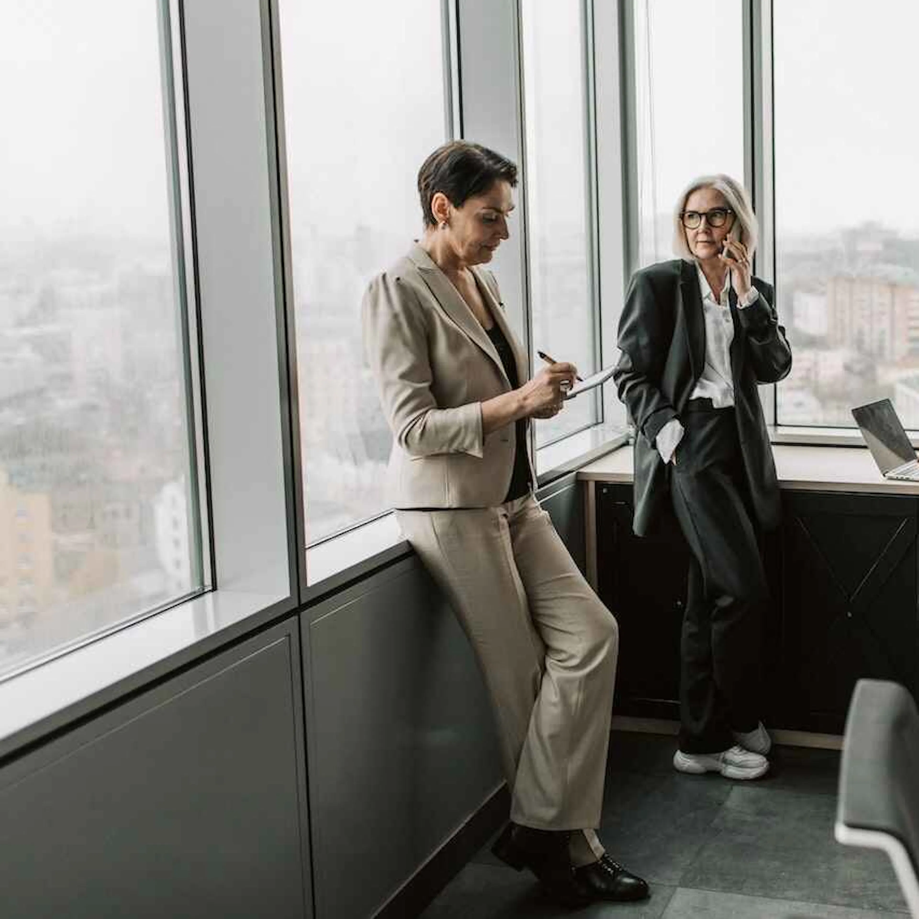 Three businesswomen working in an office with windows