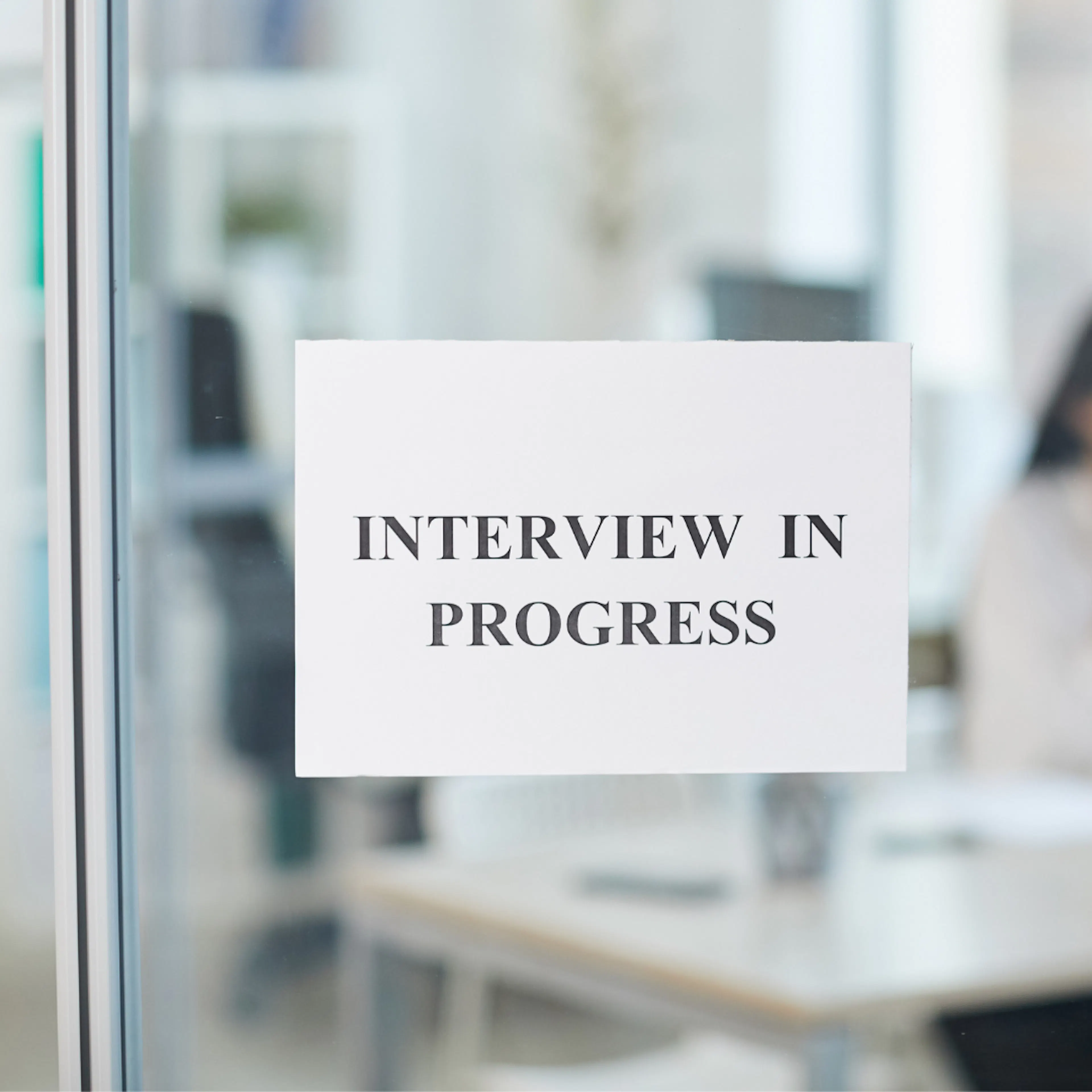 Sign outside meeting room stating interview in progress