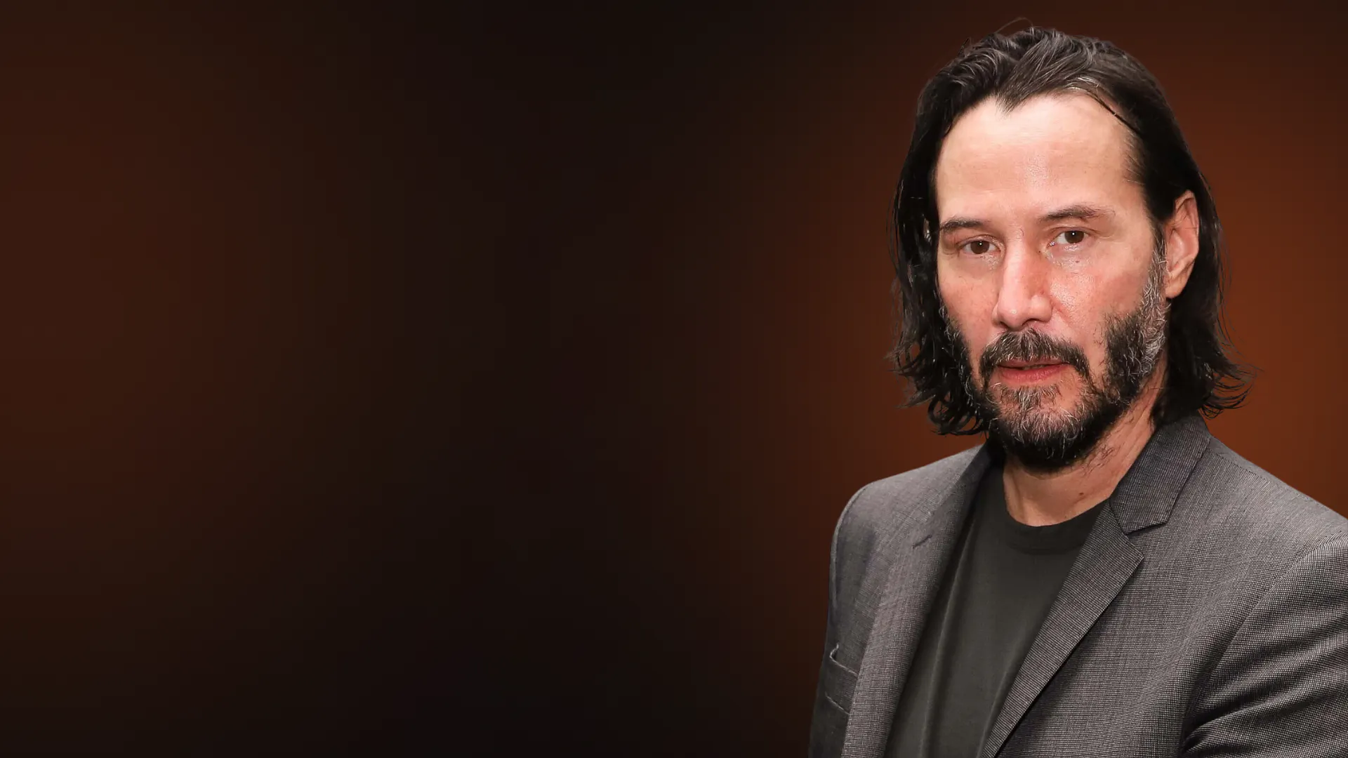 Keanu Reeves looking into the camera.