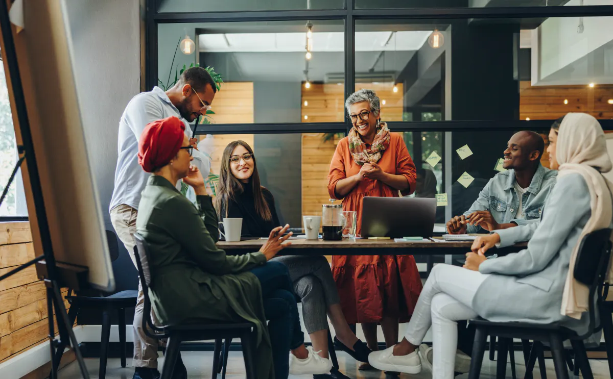 A diverse workplace team sharing a joke.