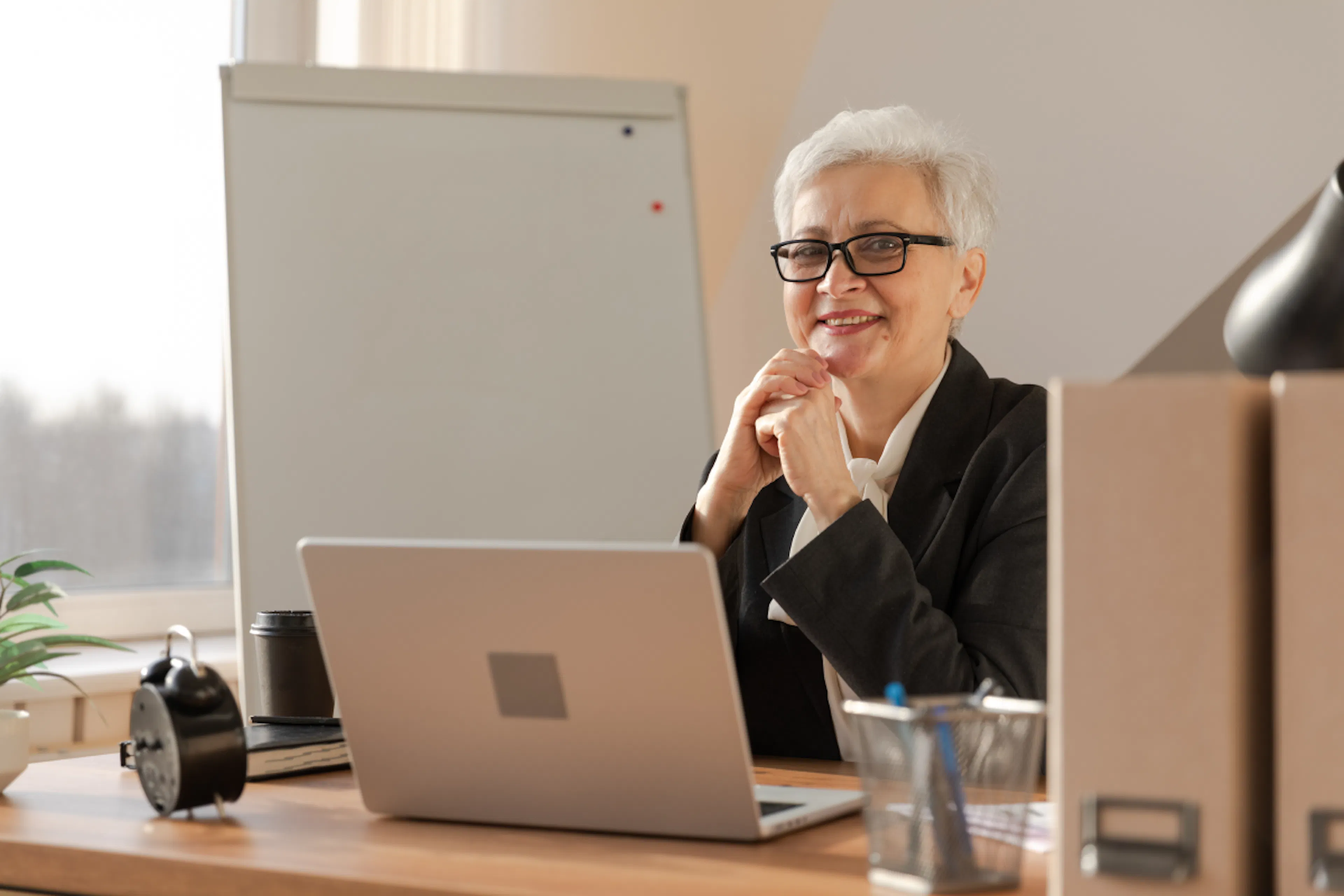 A midlife female executive at her desk.