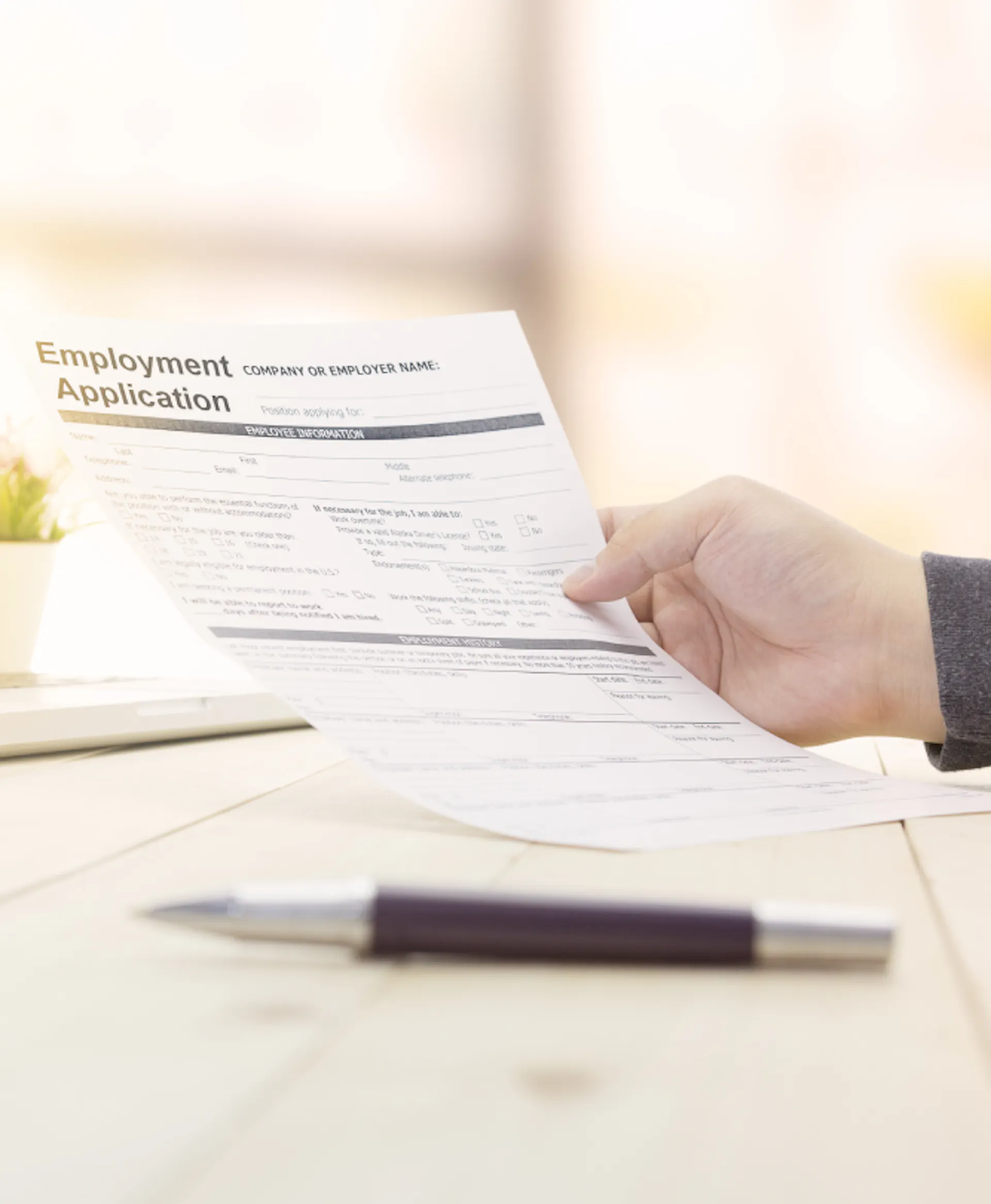 A jobseeker looks at a job application form.