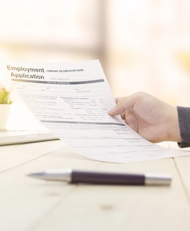 A jobseeker looks at a job application form.