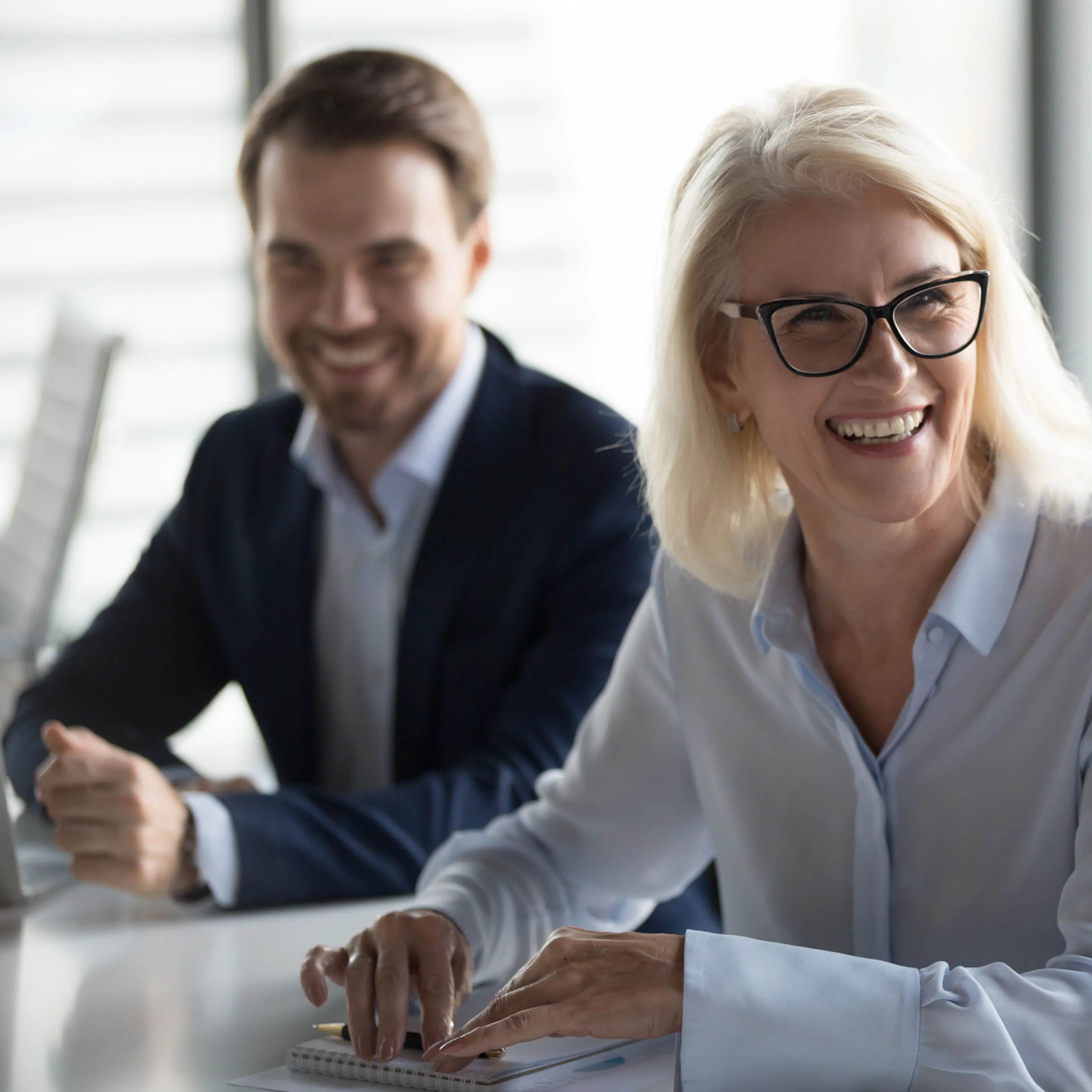 Business woman smiling at colleagues
