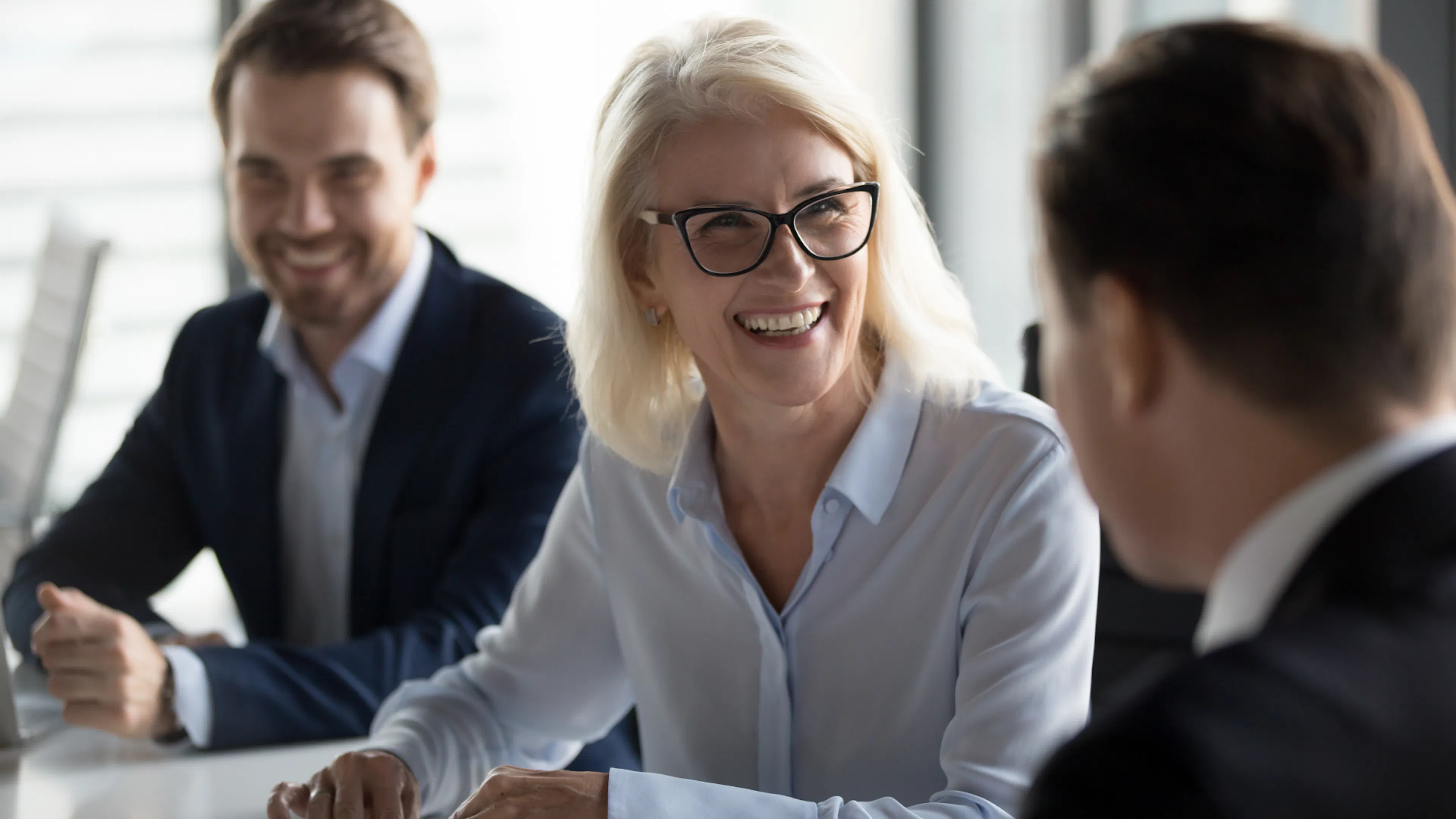 Business woman smiling at colleagues