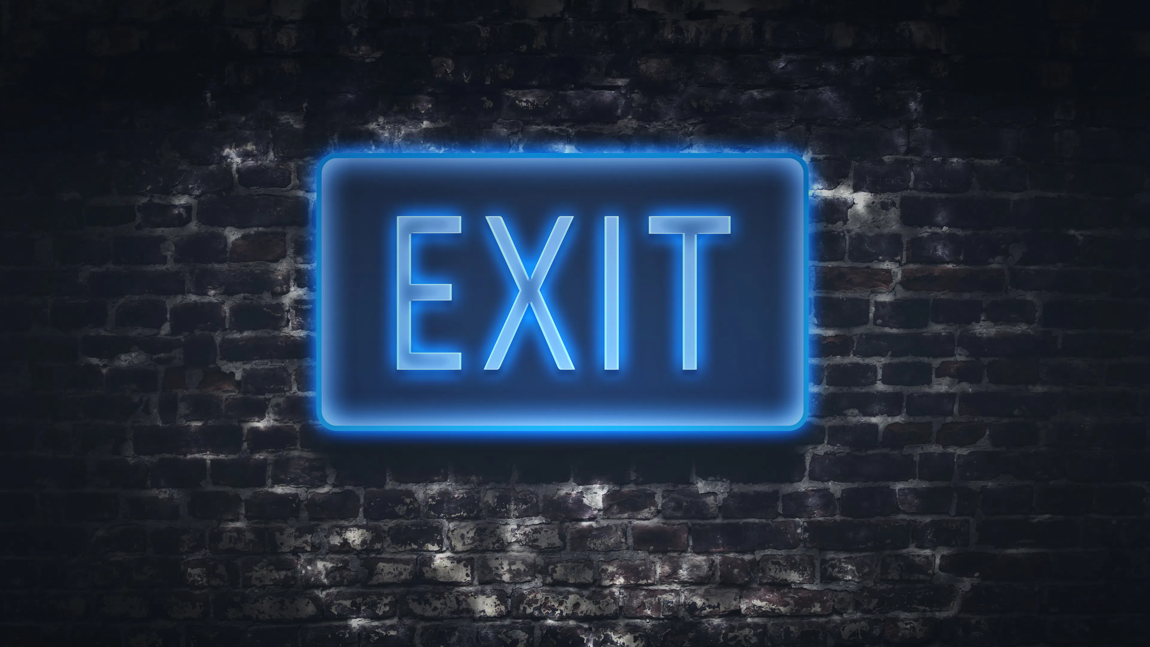 blue fluorescent exit sign on brick wall