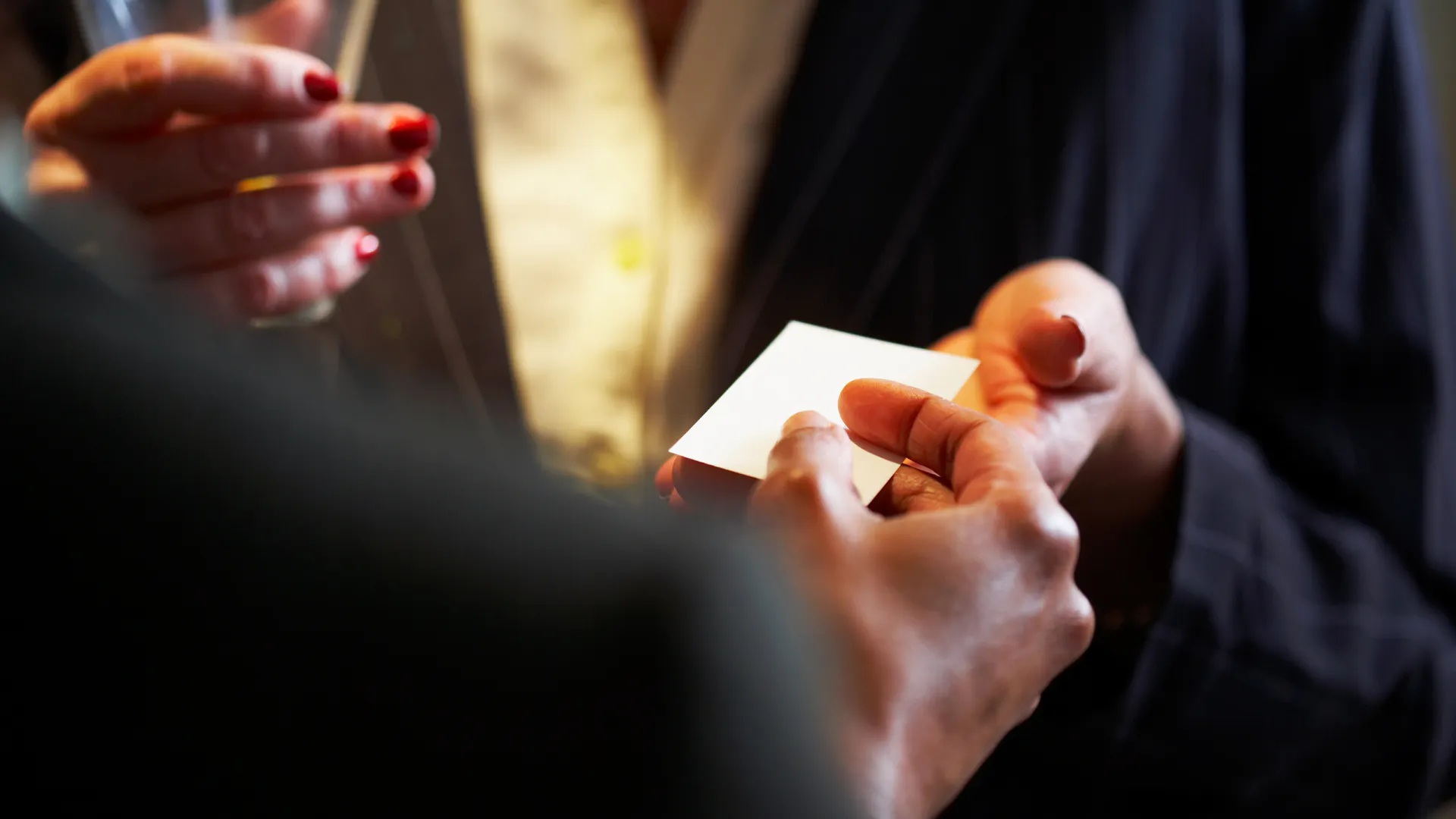 Business card being passed over