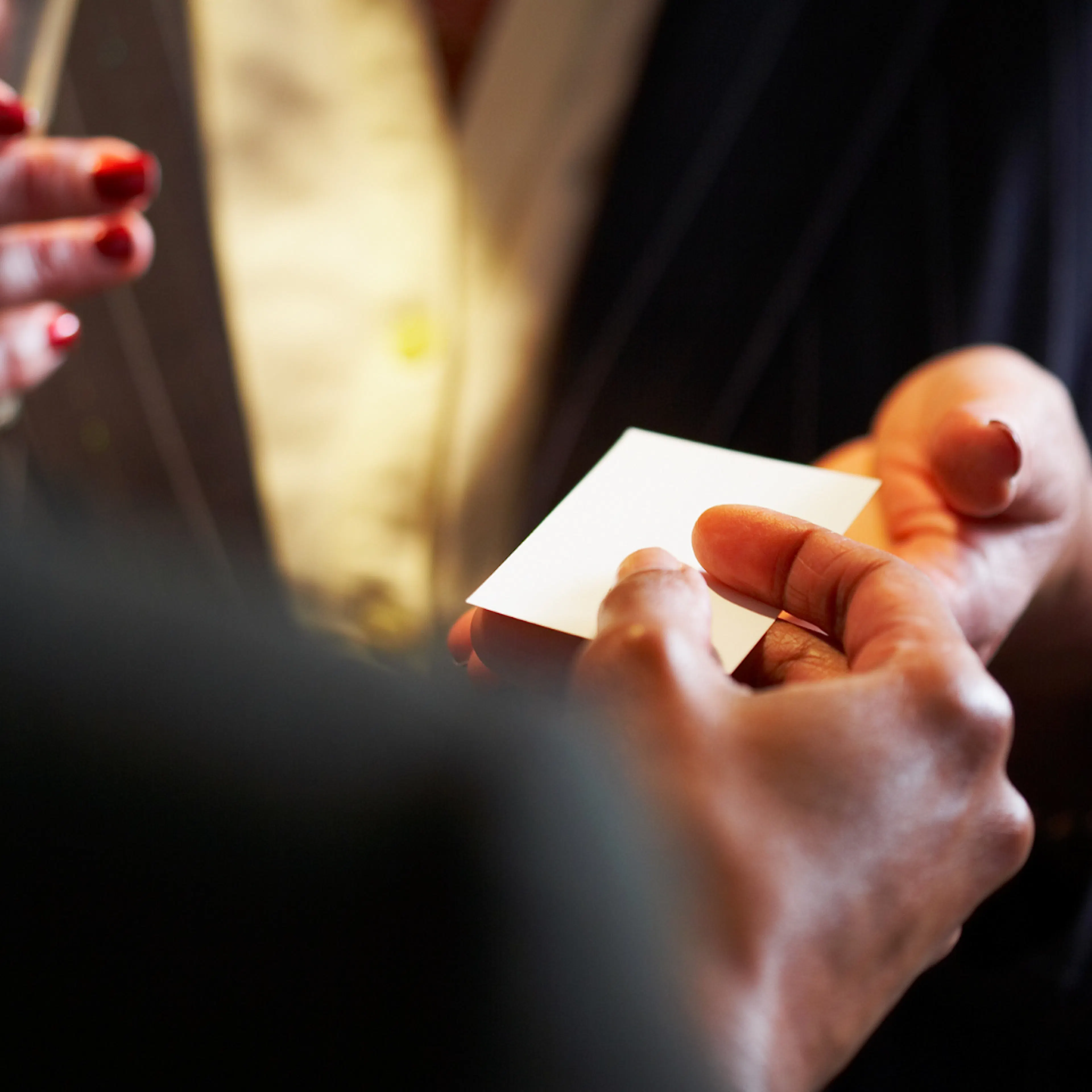 Business card being passed over