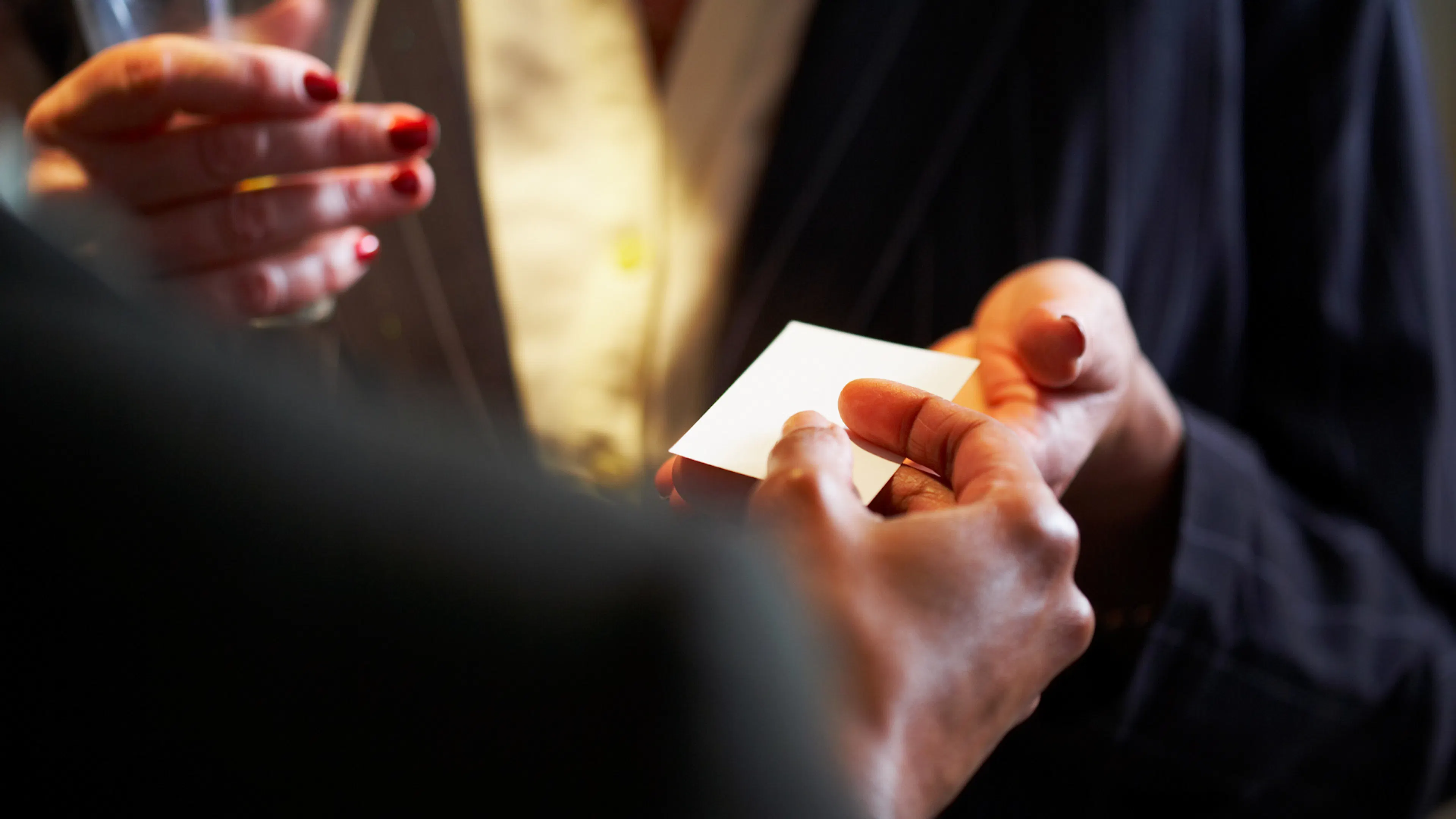Business card being passed over