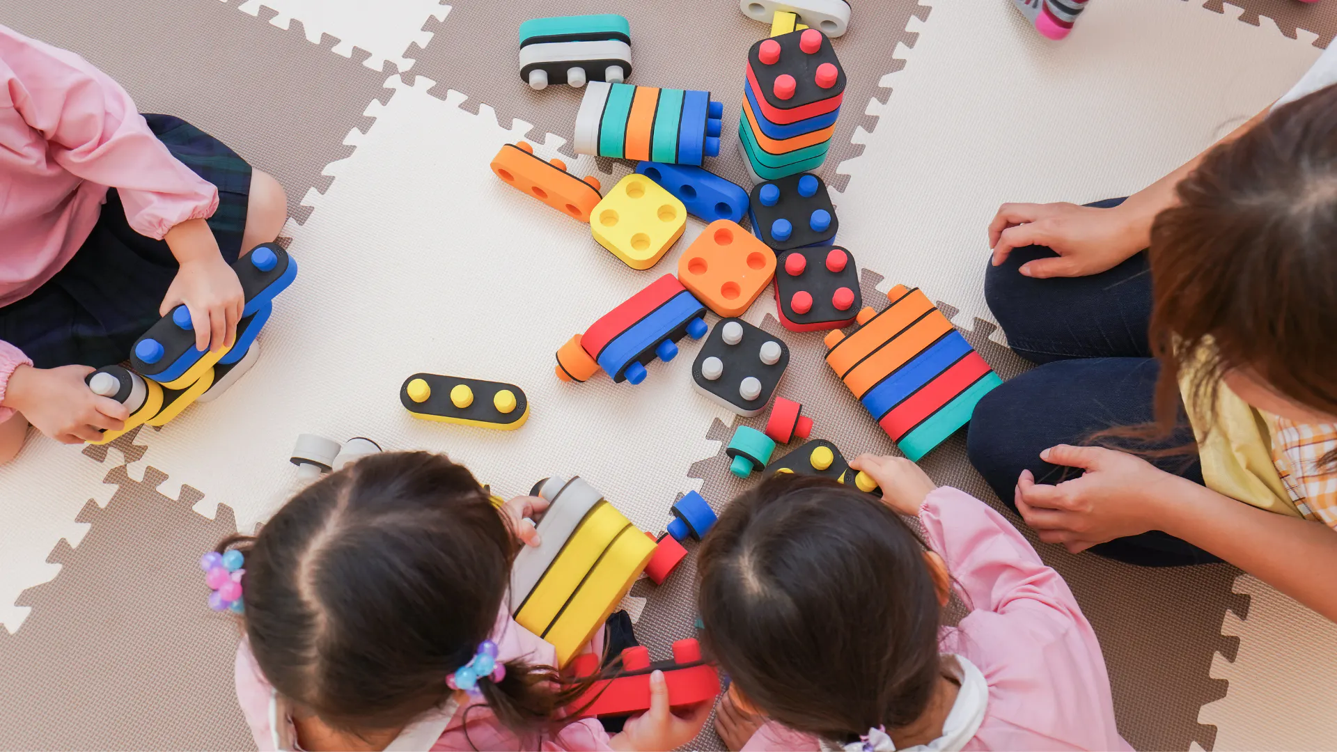 Aerial view of small children playing with toys