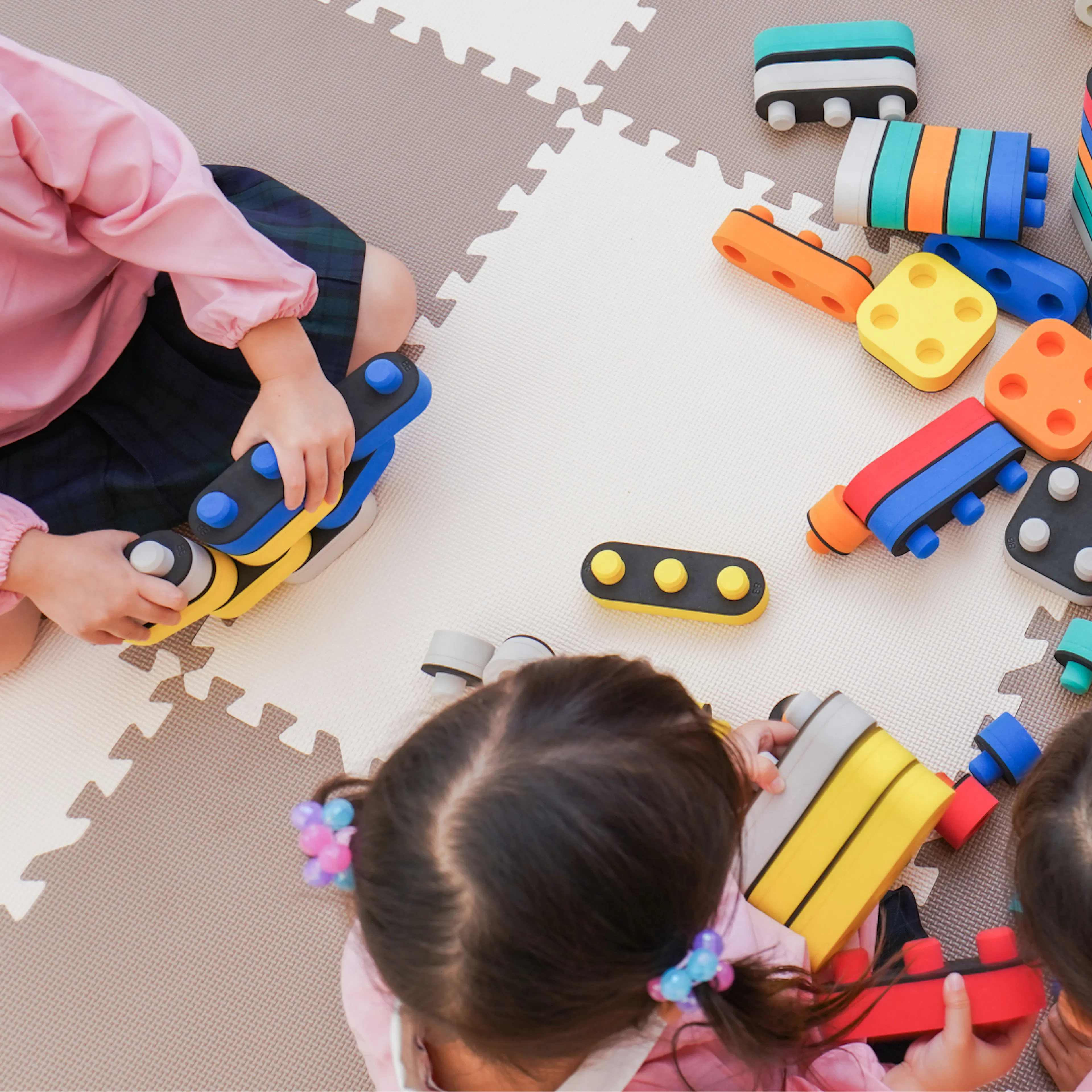 Aerial view of small children playing with toys