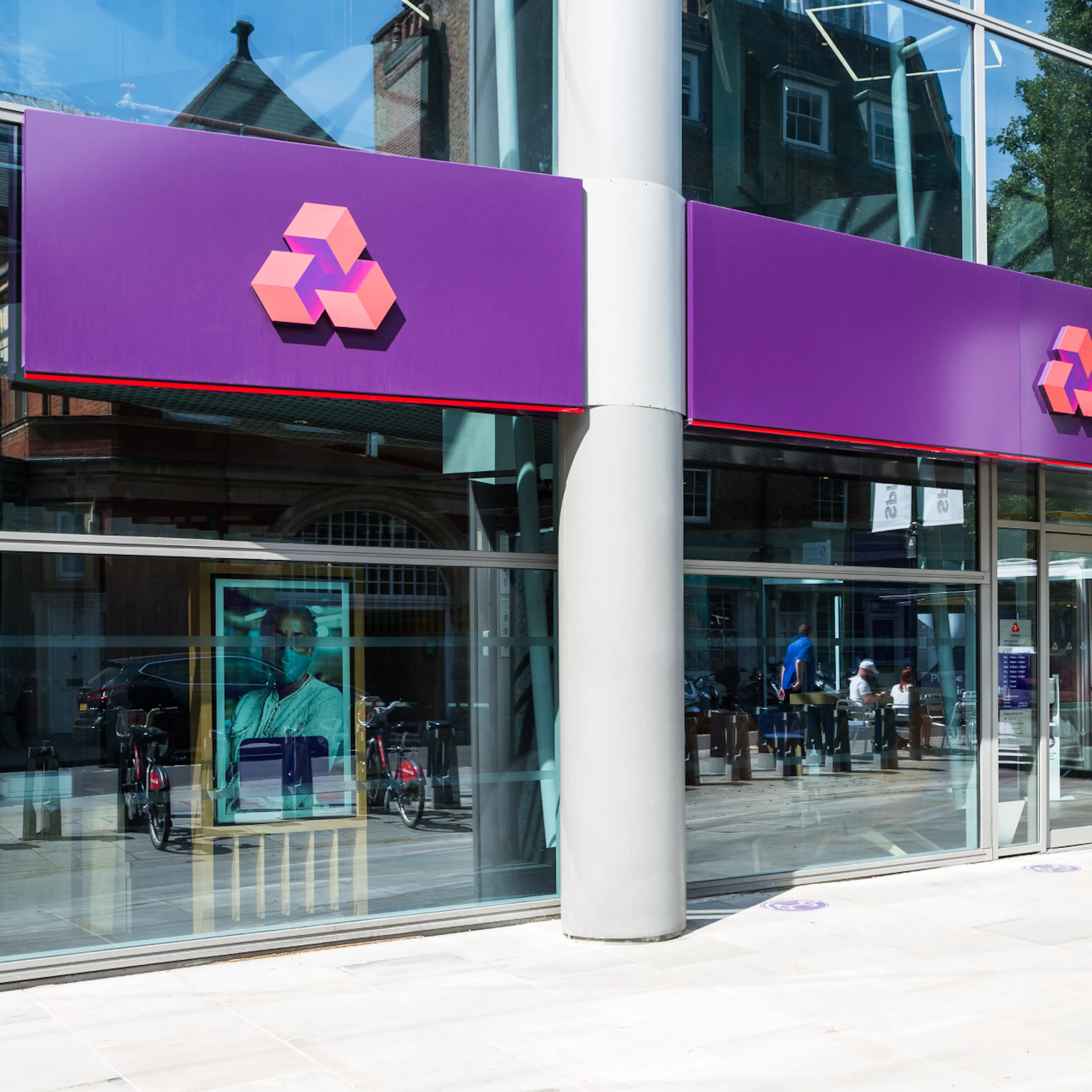 Outside a branch of NatWest in the sunshine.